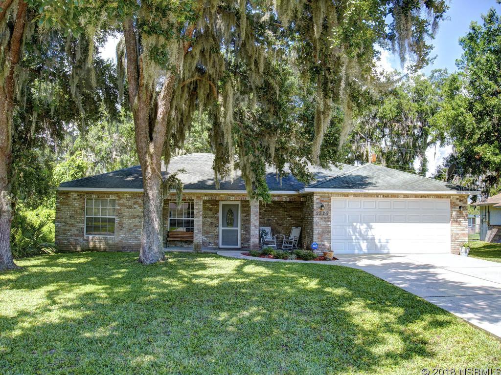 This charming 3/2 concrete block home with brick exterior is shaded by beautiful mature Florida Live Oaks and is move-in ready.  This home features a highly desirable split bedroom floor plan with vaulted ceilings and a bright large great room.  The main living area adjoins to the impressive kitchen that boasts sleek stainless steel appliances, a breakfast bar that seats 3 or 4 and lots of storage and counter space.  From the kitchen you will love the convenience of the inside utility/laundry room.  Both spaces have been recently painted and share newer laminate flooring. The master is spacious and has a walk in master closet and Jack and Jill sinks.  Sliding glass doors from the living area, open up to the cozy back patio with a charming pagoda and is partially screened in for comfort and privacy.  This alluring space looks out to the fenced in back yard, custom stone fire pit and a view of the pond.  Other features include the 2 car garage, hurricane shutters and utility shed.  This house is full of must see built in features and extra touches and when combined with its convenient Florida Shores location near to schools, shopping, and dining opportunities you wonât want to miss this chance to make it your new home. ;Water: City