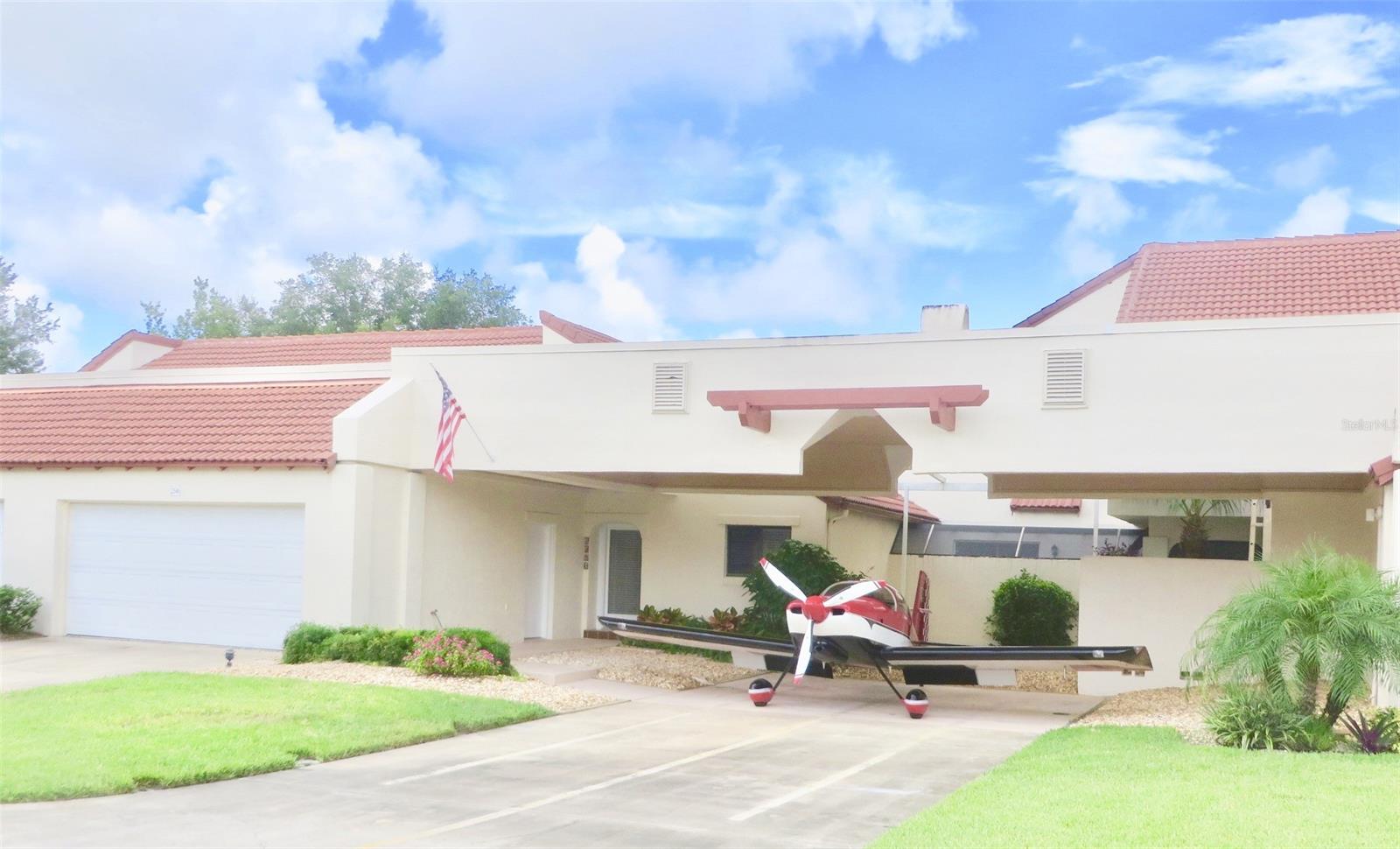 Affordable Eagle's Landing Condo with Planeport & attached 2-car garage in 24/7 gated Spruce Creek Fly-In Community! This unique single-story home offers open concept Living/Dining rooms with a cozy fireplace which overlooks your private screened Courtyard with Chattahoochee Rock. Also, within the Courtyard is a private Guest Suite with it's own separate entrance. This home features a vintage kitchen with all appliances, new carpet & was just completely repainted, inside & out. New tile roof in 2017. Plane Port is 40' wide x 32' deep, tail width 14' and height 18'; large enough for Single Engine or Light Multi Engine Aircraft. This HOA now allows a hangar door to be added to the Planeport, making it a secure aircraft hangar! All rooms have sliders to private courtyard. The Master Suite has 4 closets. Private Guest Suite (could be In-Law Qtrs.) is plumbed for kitchenette & has separate entrance from Courtyard. Eagle's Landing HOA is $672 per month & includes weekly lawn care, maintenance of exterior of condo, roof, insurance & pest control. SCPOA annual assessment is $1550. Spruce Creek Fly-In offers it all! Residents can literally fly home to their private gated airport community, golf, play tennis, pickleball or dine at their country club then drive a short few miles & frolic on the gorgeous sand & surf of the World Famous Daytona Beach. The community offers 24/7 roving security, private 4000' paved runway with GPS approach & VASI lights. Country Club Membership opportunities are available for golf, tennis, pool, fitness center, restaurants & lounge. Also in the neighborhood are the Downwind Cafe, hair & massage salons, Children's Park & Overlook Park. Located minutes to shopping, theatre, more restaurants, good schools including Embry Riddle Aeronautical University & an hour from Orlando & attractions. ;LocationDescription: Condo ;Water: City