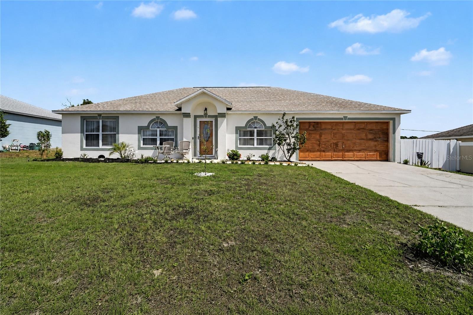 Welcome home to this spacious concrete block residence offering 2,056 square feet of living area and 2,567 total square feet under roof. Built in 2001, this well-maintained home features a 2017 roof, 2018 air conditioner, 2025 water heater, 2023 privacy fence and a recently textured garage floor providing an attractive non-slip surface. Ideal as a starter home, retirement home or anything in between, this property offers a flexible and functional floor plan with no wasted space. The versatile layout provides multiple living and dining options to suit your lifestyle, enhanced by soaring vaulted ceilings that create an open and inviting atmosphere throughout. The spacious eat-in kitchen is designed for everyday living and entertaining, featuring a full appliance package, walk-in pantry, abundant cabinet and counter space, center island with a second sink and convenient access to the covered patio through sliding glass doors. An inside laundry room includes washer and dryer. Flooring consists of laminate, tile and carpet throughout. The desirable split-bedroom floor plan provides privacy for guests, with two secondary bedrooms sharing a remodeled bath featuring marble vanity and tub/shower combination. The oversized primary suite offers vaulted ceilings, dual closets and a spacious en-suite bath complete with a garden tub, separate walk-in shower, vanity area and private water closet with window. Outdoors, the fully fenced backyard provides ample room for a future pool and includes a 16-by-12-foot shed with electricity, window, and workshop/storage space. Built to withstand winds up to 180 mph, the shed is ideal for hobbies, projects or additional storage. The covered patio features a custom wood privacy wall that provides shade from the afternoon sun, creating the ideal setting to relax and enjoy your favorite beverage. Additional features include gutters surrounding the entire home and an 80-by-125-foot lot. Conveniently near shopping, dining, medical facilities, schools and major roadways, with Deltona Commons, Providence Plaza and Deltona Plaza just minutes away. Orlando Sanford International Airport is approximately 15-20 minutes away, Downtown Orlando approximately 40-50 minutes away, and Orlando International Airport approximately 40-50 minutes away, making this an ideal location for commuters and travelers alike.