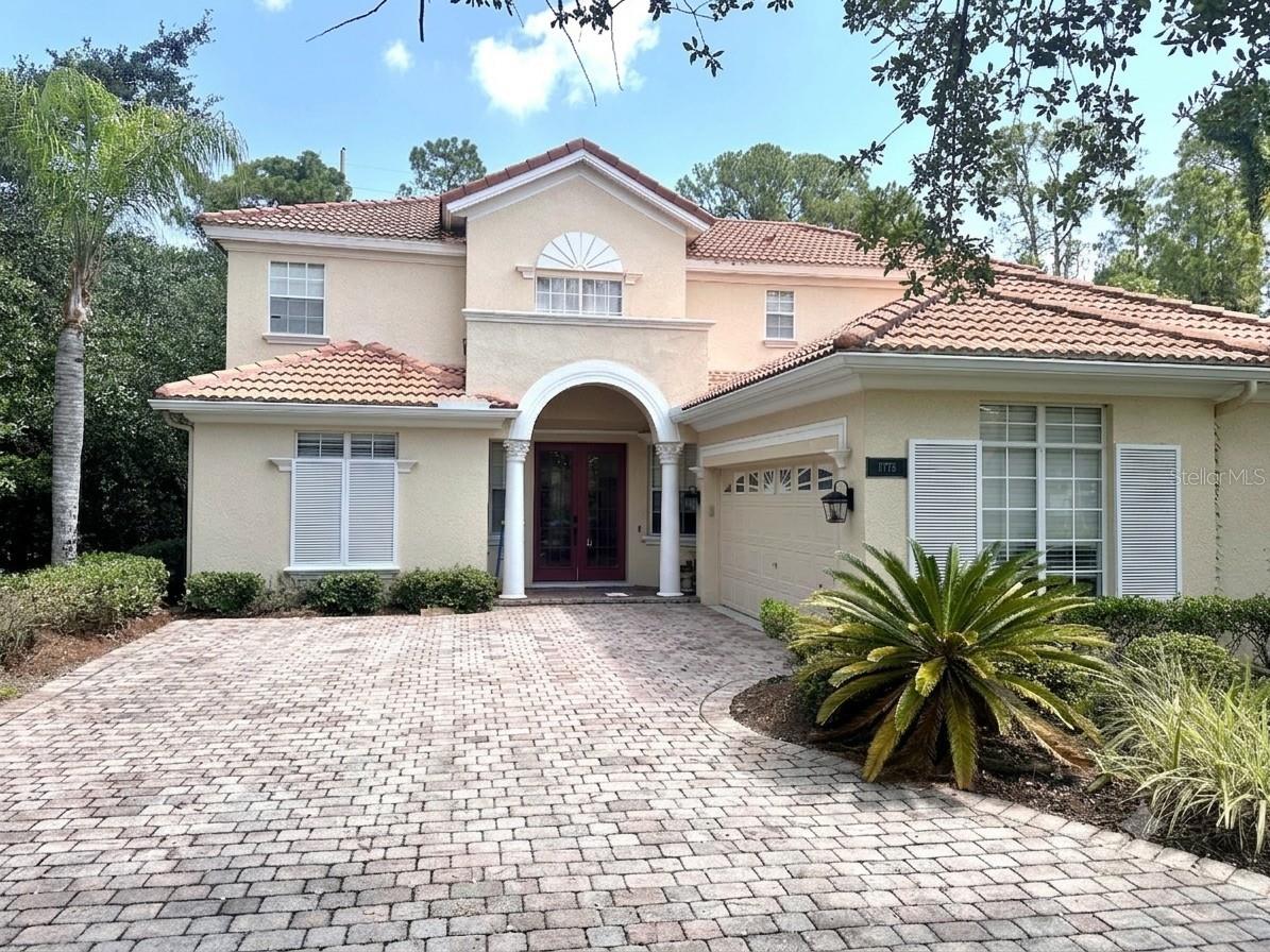 Virtually Staged. Welcome home to 11773 Bella Milano Ct — a 5-bedroom, 3.5-bath residence on a quiet cul-de-sac in the sought-after gated community of Belmere Village. Enjoy rare privacy with a wooded conservation view at the rear, bordering a park with no through-access, and a lot size just under a quarter acre.

Inside, engineered hardwood and tile flooring flow through the main living areas (one living room is carpeted), beneath vaulted and 9'4"+ ceilings on the first floor. The spacious primary suite is a true retreat, featuring a garden tub, separate shower, dual vanities, private toilet closet, walk-in closet, and an adjoining sitting room with its own exterior entrance to the backyard. Four additional bedrooms deliver flexible space for family, guests, or a home office.

The kitchen features stainless steel appliances. Seller offering up to $10,000 in concessions toward closing costs, rate buydown, and/or home upgrades.

Major systems are well maintained: both HVAC units have been replaced (2023 and 2026), and the tile roof was resurfaced in 2023 with no major repairs since. A 2-car garage completes the home.

Belmere's $130/month HOA includes a gated entrance, community pool, clubhouse, tennis courts, basketball court, sand volleyball court, playground, and fitness center — all within Windermere's top-rated school zone and minutes from the Butler Chain of Lakes and Winter Garden's Plant Street district.