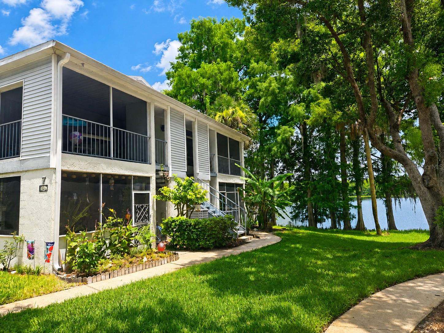 Welcome to your hidden lakefront paradise on the shores of Lake Minnie! Located in the heart of Sanford, this gorgeous first-floor condo offers 2 bedrooms, 2 bathrooms, and 912 sq. ft. of comfortable, turnkey living.

The interior has been refreshed with Bear Premium Plus paint, new bifold doors, and brand-new carpeting throughout. The inviting living room is anchored by a cozy fireplace for cool evenings, while both bathrooms feature ceramic plank flooring, updated vanity mirrors, and modern LED vanity lights with a built-in nightlight feature. Enjoy cooking for friends or family with a stunning lake view right from the kitchen! Step outside onto the screened-in front porch, complete with fresh exterior carpeting and a dedicated laundry utility closet with the washer and dryer included.

Tranquil, picturesque lake views greet you from every single window to easily melt away daily stress. Beyond the condo itself, the community features fantastic resort-style amenities, including a clubhouse, a fitness gym, a sparkling pool, tennis and racquetball courts, and a private community dock leading directly out onto Lake Minnie!

Enjoy unmatched convenience with fast access to historic Downtown Sanford, local dining, boutique shopping, Lowe's, Home Depot, SFB Airport, OIA Airport, I-4, and the 417. Bring your buyers to experience this rare waterfront gem before it's gone!