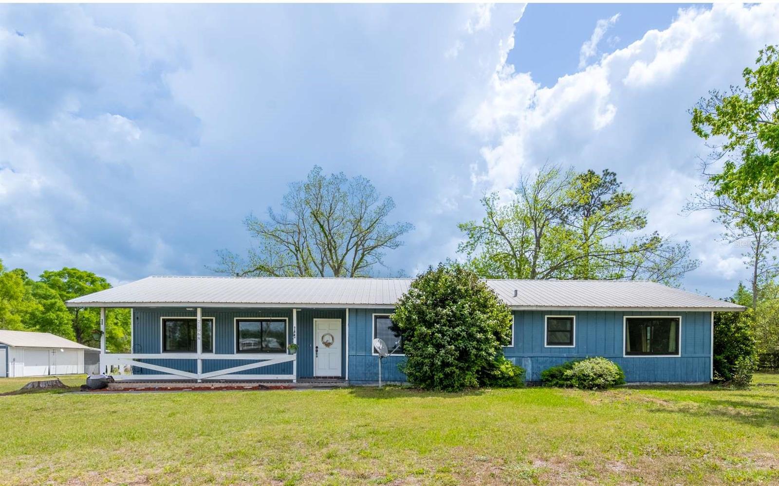 HIGHLY MOTIVATED SELLER!!! BRAND NEW SEPTIC SYSTEM!!! Experience the perfect blend of comfort and country living on this beautifully updated home situated on 2.3+ acres with no deed restrictions. This single-story residence offers 3 generously sized bedrooms and 3 full bathrooms, with the owner’s suite bath ready for your personal finishing touches. Inside, you’ll find a light-filled, open layout featuring a spacious family room centered around a cozy wood-burning fireplace—ideal for gathering and relaxing. The renovated kitchen showcases modern updates and flows effortlessly into the dining area, creating a great space for everyday living or entertaining. A bright Florida room adds even more versatility, perfect for enjoying morning coffee or hosting guests. Recent upgrades include 9 new windows installed in 2021, enhancing both efficiency and natural light, as well as a completely redone septic system, providing added value and peace of mind for years to come. Step outside to a screened back porch overlooking your private acreage, offering plenty of room to enjoy the peaceful surroundings. Additional features include a large powered workshop and a detached two-car garage, providing ample space for storage, hobbies, or equipment.