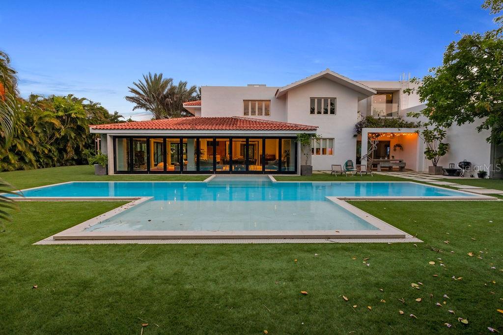 This luxurious 8,706 sq. feet property has 5 bedrooms, 6.5 bathrooms, two spacious living areas , modern, fully equipped kitchen, a great terrace, gas grill and outdoor furniture plus lounge chairs, and one 4 passenger golf cart. The house is 2-3 miles from the beach (less than 10 minutes in golf cart) and less than a mile from the Wellness and Tennis center, and Windmill Waterpark. 

The Dorado Beach East community is private, gated, family friendly and offers a wide range of facilities that you can enjoy at no additional cost. The facilities include scenic pools, clay tennis courts, basketball and beach volleyball courts, a basic gym, a game room, a 3-par golf course that winds through the neighborhood, and an aviation themed park which has a custom water park and sand park.

Located within the Dorado Beach Resort, since it is a 2,000-acre natural reserve most of the communities are 1-3 miles away from the beach and Hotel. This being said, the entire resort is interconnected via golf cart trails, meaning that you can have easy access (walking or in golf cart) to the different communities and amenities within this Resort.