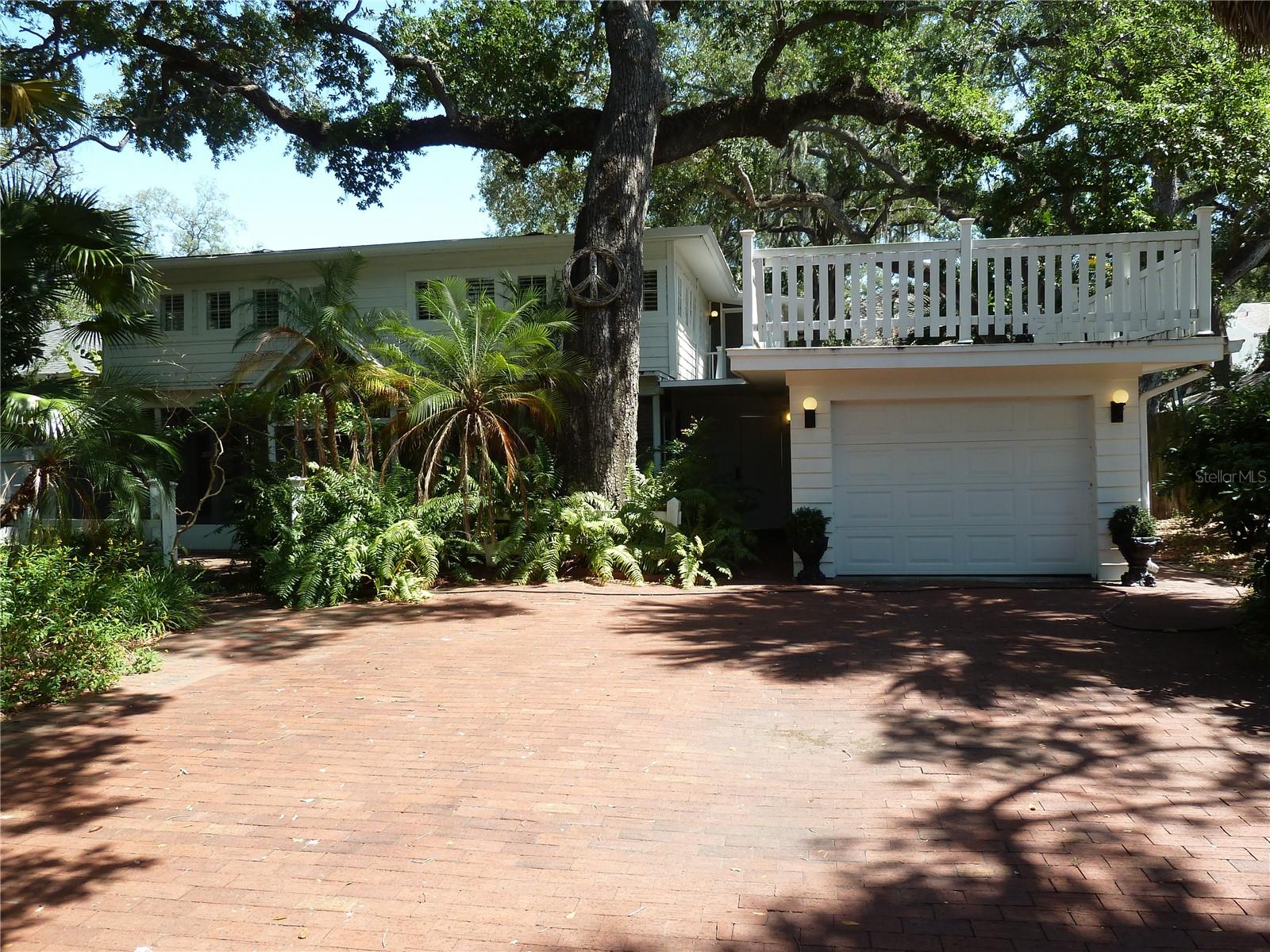 Just minutes from the iconic waterfront of Bayshore Boulevard, this South Tampa property presents a rare opportunity to restore a home filled with history, character, and timeless architectural details or create the custom home you've always envisioned.

A brick paved walkway winds through lush tropical landscaping, leading to a spacious screened front porch that hints at the home's once elegant charm. Inside, you'll find original details that are increasingly difficult to replicate, including plantation shutters, beadboard ceilings, crystal glass doorknobs, genuine hardwood floors, and diagonal ceramic tile. The two bedroom, one bathroom main residence is filled with unique architectural character and nostalgic craftsmanship that serves as the foundation for an extraordinary restoration.

Adding to the property's appeal is a detached garage with a charming one bedroom, one bathroom guest house above, creating the perfect private retreat for overnight guests, extended family, a home office, or future rental possibilities. Above the garage, you'll also discover a unique fenced rooftop terrace, an inviting space for entertaining, hosting intimate gatherings under the stars, or simply enjoying your own private outdoor escape.

This property is in need of significant renovation and is being offered for buyers with the vision and resources to restore it to its former beauty or take advantage of the exceptional homesite to build a stunning new custom residence. Opportunities like this are becoming increasingly rare in one of South Tampa's most coveted neighborhoods.

Whether your passion is preserving historic charm or creating a luxury estate from the ground up, this property offers an exceptional canvas in an unbeatable location, just moments from Bayshore Boulevard, premier dining, shopping, downtown Tampa, and everything that makes South Tampa one of the area's most desirable places to call home. Schedule a tour today!