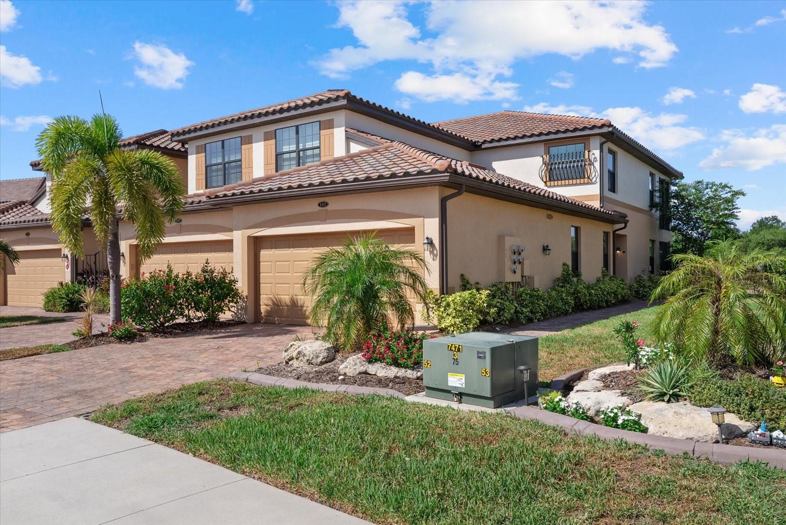 Experience the perfect blend of luxury, comfort, and resort-style living in this beautifully maintained first-floor end-unit coach home located behind the gates of the highly sought-after Gran Paradiso in Wellen Park. Offering 3 bedrooms, 2 baths, a spacious 2-car garage, and tranquil water views, this residence delivers the Florida lifestyle you've been searching for.

Filled with natural light, the open-concept floor plan is designed for both everyday living and effortless entertaining. The expansive screened lanai provides the perfect setting to enjoy morning coffee, evening sunsets, or simply relax while overlooking the peaceful lake.

The thoughtfully designed split-bedroom floor plan offers privacy for family and guests. At the heart of the home, the spacious kitchen features solid wood cabinetry, stainless steel appliances, abundant counter space, and a large breakfast bar that flows seamlessly into the dining and living areas.

Retreat to the impressive owner's suite featuring dual walk-in closets, dual vanities, a luxurious garden tub, and a separate walk-in shower, creating your own private spa-like escape. Hurricane-impact windows and a fire sprinkler system provide additional comfort and peace of mind.

Life at Gran Paradiso feels like living at a private resort. Residents enjoy an elegant clubhouse, resort-style pool and spa, state-of-the-art fitness center, tennis and pickleball courts, sauna, library, billiards room, and miles of scenic walking and biking trails. Just minutes from Downtown Wellen, CoolToday Park, championship golf, world-famous Gulf beaches, waterfront dining, shopping, and entertainment, you'll be at the center of one of Southwest Florida's fastest-growing and most desirable destinations.

Whether you're looking for a full-time residence, seasonal retreat, or investment opportunity, this exceptional home offers the perfect combination of location, lifestyle, and value. Schedule your private showing today and discover why so many are choosing to call Gran Paradiso home.
