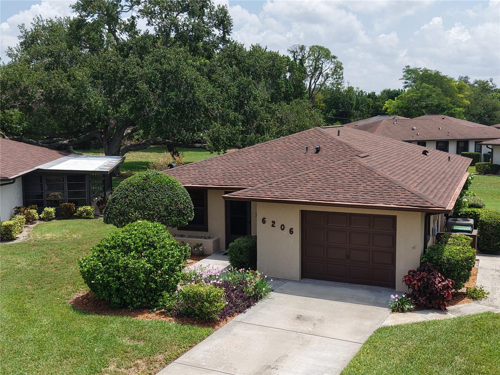 Welcome to Cambridge Village West, a close-knit 55+ condominium community located in the heart of highly sought after West Bradenton. Consisting of 104 freestanding homes with attached garages, this community offers many opportunities to enjoy the relaxed Florida lifestyle and gather with neighbors and friends. Come make memories year-round at the community clubhouse, featuring a large, heated pool, shuffleboard court, outdoor grill, indoor kitchen with dining area, and fully stocked library.
This neat 2/2 home offers a relaxed and surprisingly spacious feel tucked into a private, picturesque setting. A large, air-conditioned sunroom lets in natural light and overlooks the parklike backyard and centuries old oak tree. The floor plan lives larger than expected and features two updated bathrooms with granite countertops and new comfort-height toilets. The master bedroom features a huge walk-in closet, and additional storage is plentiful throughout the home. Other updates include a new shingle roof (2024), well-maintained A/C (2019), and newer GE appliances, including indoor washer and dryer.
The HOA works hard to ensure the community is both safe and attractive. Considered to have one of the most affordable monthly fees at just $293, residents can rest easy knowing that landscaping, home maintenance including exterior painting, and even Spectrum cable TV and high-speed internet are all included. Additionally, residents enjoy the convenience of being within a mile radius of medical facilities and Blake Hospital, recreational activities and walking trails at GT Bray Park, and a variety of restaurants and local shopping. Located only 10 minutes from gorgeous gulf coast beaches, residents can enjoy the lifestyle visitors only dream of!