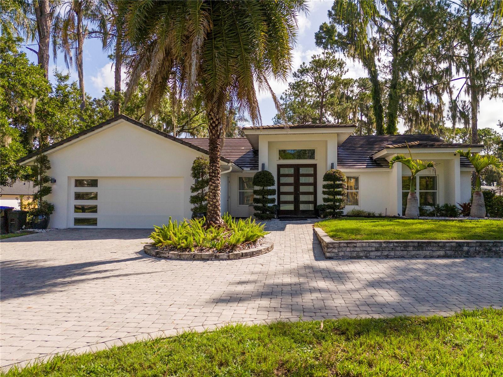Welcome to an exceptional lakefront opportunity on the upscale Butler Chain of Lakes. Situated on a beautifully landscaped 0.80-acre lot in the Cypress Shores community, this custom 3-bedroom, 2-bath residence offers direct frontage on Lake Tibet with convenient access to the channel leading to Lake Sheen and the remaining lakes of the renowned Butler Chain.
Designed with exceptional craftsmanship, the home showcases extensive custom millwork and built-in cabinetry throughout, creating a distinctive architectural aesthetic that blends rich hardwood finishes with clean contemporary lines. Vaulted and cathedral ceilings, skylights, and abundant natural light enhance the spacious open-concept living and dining areas, while the thoughtfully designed split-bedroom floor plan provides privacy for the primary suite, complete with custom built-ins and a beautifully appointed en-suite bath.
The kitchen is both functional and elegant, featuring stainless steel appliances, including a Samsung touchscreen refrigerator, built-in microwave, and an under-counter wine cooler for wine enthusiasts. Stunning Grigio Carnico Italian marble countertops beautifully complement the soft-close cabinetry, creating a refined space for cooking and entertaining. Adjacent to the kitchen and main living area, the rear family room offers breathtaking views of the landscaped backyard and Lake Tibet, providing the perfect place to relax while enjoying the waterfront setting.
Both bathrooms are elegantly finished with Italian marble and custom stainless-steel fixtures, reflecting the same attention to quality and detail found throughout the home.
The expansive lanai overlooks the tranquil waterfront, creating the perfect setting for entertaining or relaxing while enjoying panoramic lake views. The generous 0.80-acre lot offers exceptional potential for future outdoor enhancements, including a custom infinity-edge pool, spa, summer kitchen, and private dock (subject to applicable approvals). An oversized two-car garage provides added convenience and storage.
Located on one of the Butler Chain's most desirable lakes, this property offers access to more than 5,000 acres of interconnected waterways renowned for boating, water skiing, fishing, and year-round recreation. Ideally situated just minutes from Bay Hill, Dr. Phillips, Restaurant Row, world-class golf, shopping, major attractions, Orlando International Airport, and downtown Orlando.
With no HOA and an exceptional lakefront setting surrounded by luxury estates, this property presents a rare opportunity to own on one of Central Florida's premier waterfront chains.