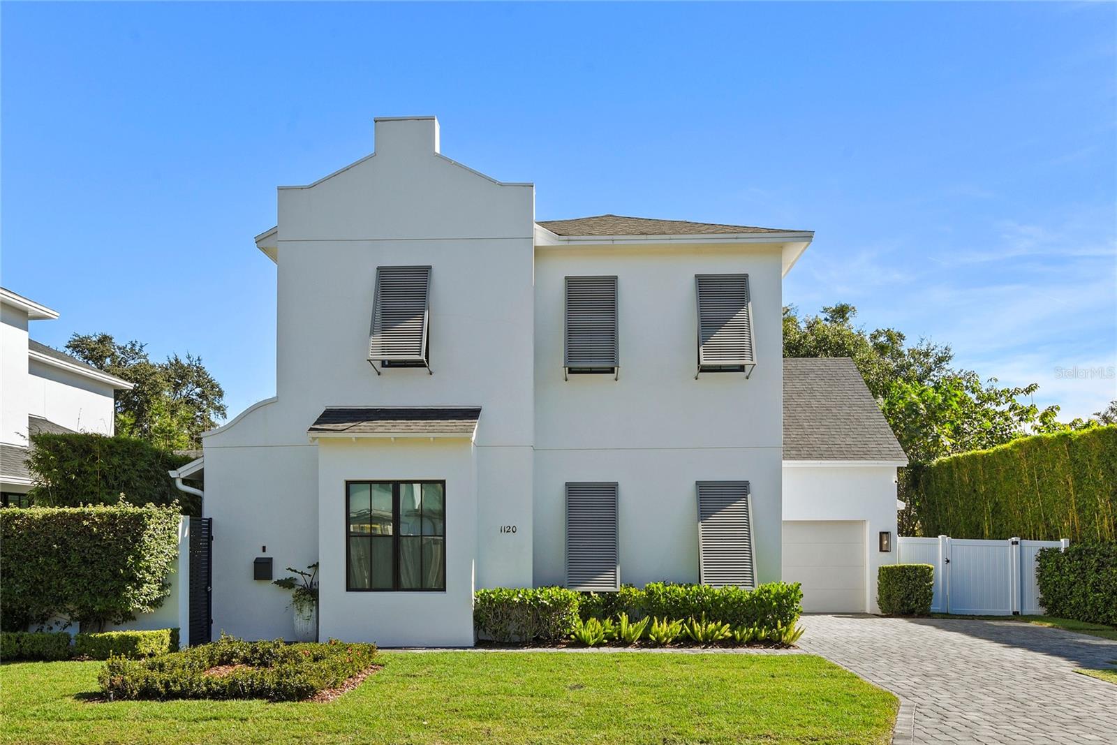 Curated with intention and finished without compromise, 1120 Wisconsin Avenue is a rare opportunity to own a bespoke Winter Park residence where elevated design meets effortless everyday living. Every detail of this 2,213-square-foot, three-bedroom, three-and-a-half-bath home has been thoughtfully considered — from the custom Pella® multi-point entry door that welcomes you into a light-filled, open-concept gathering room, to the chef's kitchen anchored by a dramatic waterfall island and ZLINE commercial-style gas range with soft-close cabinetry and curated high-end appliances throughout.
A private courtyard entry sets a serene tone before you've even stepped inside. The seamless indoor-outdoor connection continues through Pella® wood-clad sliding glass doors to a covered BBQ kitchen lanai — your own tranquil outdoor retreat. The primary suite is a true sanctuary: a generous walk-in closet, a sitting area, linen storage, and a spa-caliber bathroom with a double-sink vanity and oversized walk-in shower. Upstairs, two spacious en-suite bedrooms and a versatile loft with built-in storage offer flexibility for guests, family, or a refined home office.
Finished with stunning hardwood floors, soaring ceilings, custom window treatments, spray foam insulation, and dual-zone climate control, this home is as quietly practical as it is undeniably beautiful. Whether you're entertaining or simply unwinding, 1120 Wisconsin Avenue offers the ease and elegance of a true lock-and-leave lifestyle in one of Winter Park's most sought-after neighborhoods.