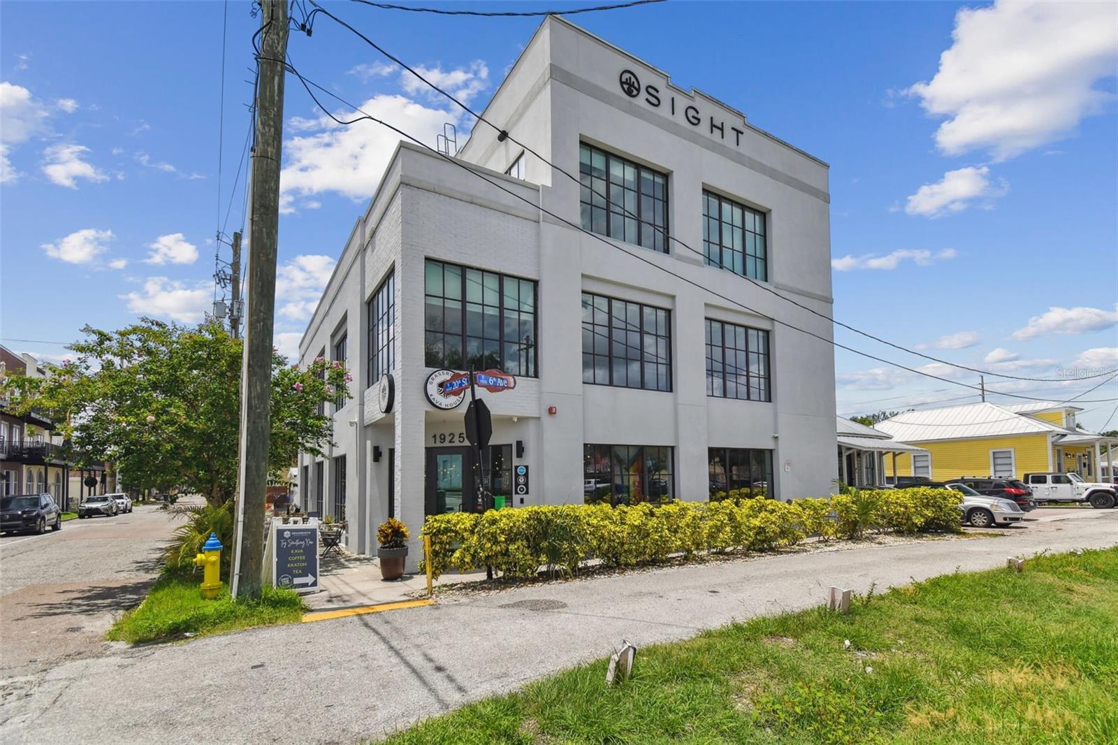 For Sale – Income-Producing Commercial Property in the Heart of Historic Ybor City perfect for an owner occupant asset with flexible in place leases with existing tenants. Step into an exceptional investment opportunity with this three-story income-producing block building ideally located in the heart of Tampa’s vibrant Historic Ybor City. With unmatched character, versatility, and built-in revenue potential, this property is perfectly positioned for an owner-user or investor seeking a premier commercial asset in one of Tampa’s most sought-after districts. The first floor is designed as a fully operational coffee shop, with fixtures and equipment that convey with the building, making it turnkey-ready for continued food and beverage use. This level also includes a private meeting room, designated parking spaces, and the benefit of wet zoning adding even more potential for hospitality. The second floor is dedicated to professional office spaces, featuring 11 private office suites, a large conference room, and a kitchenette. This level is ideal for tenants seeking a professional environment in the heart of a thriving business district, with the added convenience of private elevator access. The third floor offers a bright, open office concept perfect for collaborative work environments. It also includes three private offices, an oversized kitchen with a breakfast bar, and a private balcony overlooking Ybor City — creating an inviting mix of functionality and modern workplace comfort. Like the second floor, it benefits from secure elevator access. Call today to schedule a private showing!