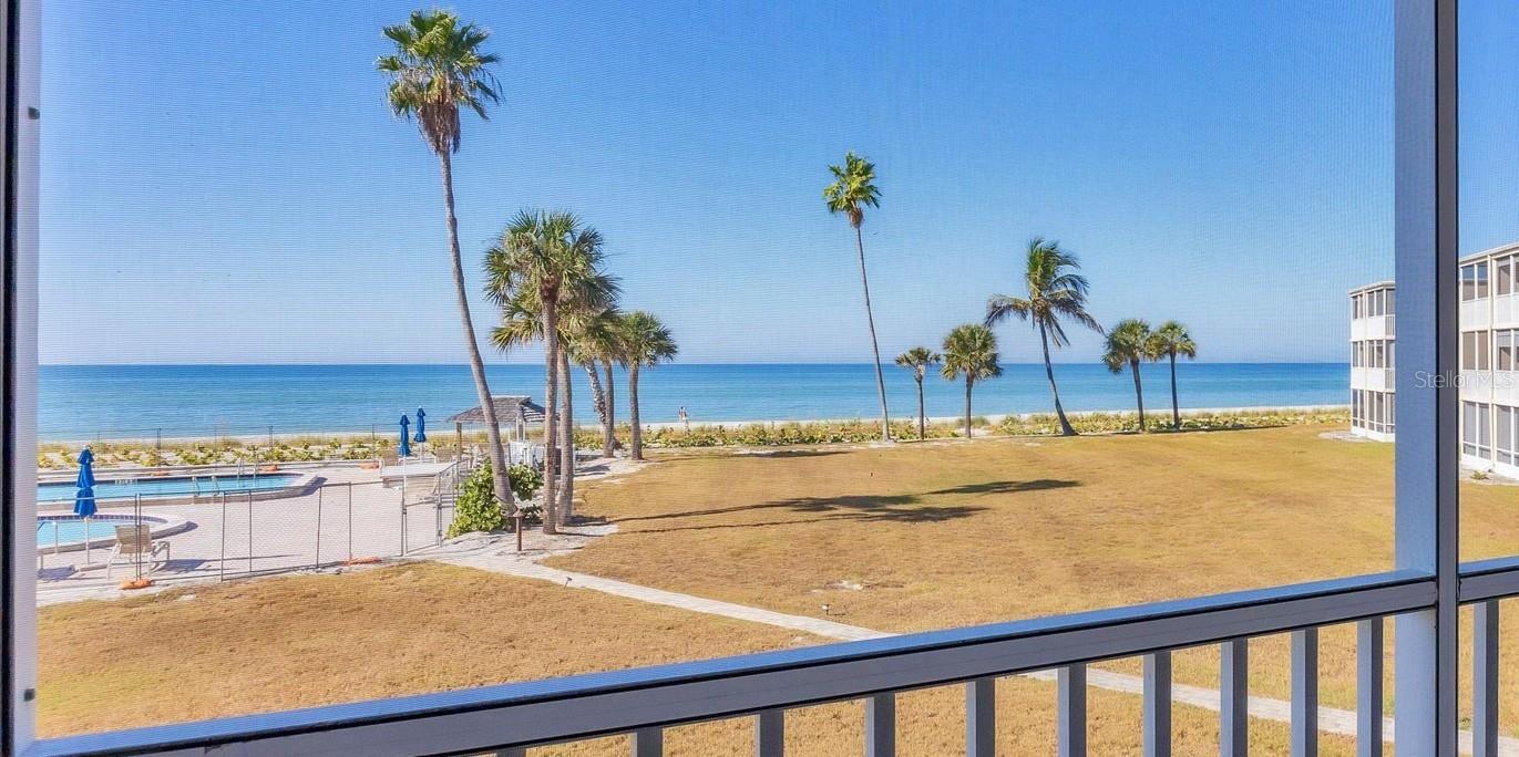 The unobstructed Gulf View greets you as you enter this 2nd floor unit. The spacious living area overlooks the large screened lanai out to the Gulf of Mexico. All units at The Westchester community have new impact resistant sliders and windows that meet Miami Dade code in order to reduce insurance premiums for all. This unit also has extra protection as both lanais have electric shutters that also help with energy cost while you are away. The windows, sliders and shutter cost were the responsibility of the owners. Brand new Hunter Douglas honeycomb blinds on both sliders. A/C is 3 years new, water heater 1 year ago. The entire unit is freshly painted and the ceilings refinished. A new GE Profile combo washer/dryer was just installed so you won’t need to use the community laundry. The galley kitchen is tastefully updated with soft close cabinetry and quartz countertops. The refrigerator was replaced 2 years ago; it has a purified water option for drinking water and ice. The primary bedroom has a private lanai that overlooks  the Gulf. Both en-suite bedrooms are split to offer privacy. Both have walk in closets as well as a second closet in the main bedroom area. The primary bathroom was renovated  with a beautiful shower and dual vanity; The second bath was also renovated and has a large Kohler soaking tub and Kohler fixtures. The guest bedroom is large enough to accommodate 2 double beds. There are 3 entry storage closets as well as a large private storage room downstairs close to your assigned carport space. Westchester is situated on 7 acres with 700 feet of beach. There are loungers on the beach, 2 heated pools, 3 beachside tiki huts, pickleball/tennis court, kayak/bicycle storage, BBQ grills and shuffleboard. The new clubhouse with fitness center is currently under construction. The Gulf side of the property is undergoing improvements to the pool area as well as landscaping. Westchester is a very well managed property with in-house manager and maintenance staff. The unit is being offered unfurnished. BE SURE TO CHECK OUT THE VIRTUAL TOUR LINK FOR THE 3D TOUR - BETTER THAN PICTURES!