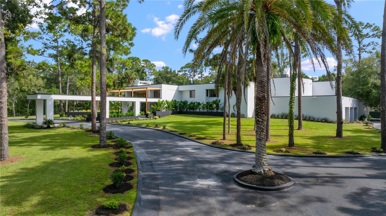 Behind the guarded gates of the prestigious Sweetwater Club, on over three acres of manicured grounds, lies an extraordinary fully remodeled 14,000+ square foot estate that redefines grandeur and sophistication. A sweeping double-entry driveway framed by mature, curated landscaping guides you to the stately façade, where timeless architecture meets meticulous design, including a new roof (2022) and freshly refined exterior finishes.  At the heart of the home, the grand family room captivates with its soaring ceilings, bespoke millwork, and custom illuminated built-ins with LED underlighting. Expansive windows invite natural light while framing serene views of the pool courtyard, ensuring every moment feels cinematic. The chef’s kitchen is a true culinary masterpiece. Exquisite quartz countertops and professional-grade stainless appliances stand ready for both intimate family dinners and grand-scale entertaining. A generous island doubles as a culinary stage and social hub, while the adjoining formal dining room, finished with refined detailing and natural light, offers the perfect backdrop for soirées and celebratory dinners. The primary is truly a room of palatial scale; the suite is wrapped in floor-to-ceiling glass overlooking the shimmering courtyard pool. The spa-inspired bath rivals the finest resorts, featuring an expansive walk-in shower with multiple rain showerheads, a freestanding soaking tub, and a spacious dressing walk-in closet. Each secondary bedroom has been designed with equal attention to luxury, spacious in proportion, each with its own walk-in closet. This estate was created for living large and entertaining even larger. The bar and lounge area, complete with its own island, is perfect for entertaining.  Outdoor living unfolds as a true resort with a screened courtyard pool, expansive travertine decking for grand entertaining, and a fully appointed summer kitchen pavilion complete with a pizza oven, built-in seating, and shaded dining space that create an atmosphere of Mediterranean resort living. Steps away, your newly resurfaced private tennis courts extend the estate’s leisure amenities, providing the perfect stage for recreation. For the automobile enthusiast, the five-car garage and sprawling motor court make a dramatic statement seamlessly integrated into the estate’s unrivaled design. Fully gated and meticulously upgraded, this estate is not just a home but an irreplaceable lifestyle, offering unparalleled privacy, scale, and elegance in one of Central Florida’s most distinguished communities. Beyond the estate, life in Sweetwater Club offers unparalleled exclusivity, you have access to tennis/pickleball courts, a basketball court, and your in a secure, guard-gated setting. Opportunities like this rarely come along, don’t miss the chance to make this estate yours.