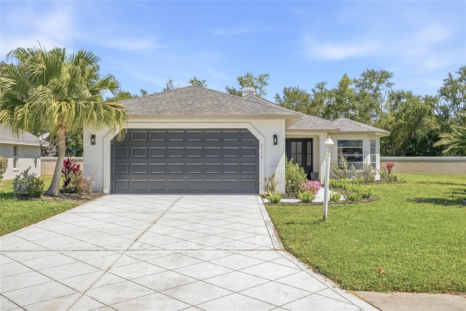 Welcome to this stunning 3-bedroom, 2-bathroom pool home with a 2-car garage, perfectly situated in the heart of Bradenton in the desirable River Landings Bluff community! From the moment you arrive, you’ll be impressed by the beautiful curb appeal, featuring fresh interior and exterior paint, lush landscaping, and mature palm trees that give the neighborhood its classic Florida charm. Step inside to a light-filled, open floor plan with soaring vaulted ceilings and a bright, airy feel throughout. The main living areas showcase brand-new luxury vinyl flooring, seamlessly connecting the spacious living and dining room combo, complete with a cozy fireplace, perfect for relaxing or entertaining. The beautifully updated kitchen is a true highlight, featuring new cabinetry, sleek quartz countertops, and brand-new stainless steel appliances, along with a charming breakfast nook for casual dining. Down the hall, you’ll find three generously sized bedrooms and two updated bathrooms, along with a unique skylight that fills the space with natural light. The home also offers a spacious laundry room with a washer and dryer for added convenience. The primary suite is a peaceful retreat, complete with direct access to the pool area, perfect for enjoying morning coffee or evening swims. Step outside to your private backyard oasis, where a sparkling, fully screened-in pool awaits, ideal for year-round enjoyment and summer gatherings. Major updates provide peace of mind, including a 2025 roof, 2023 HVAC system, and a 2026 water heater. Located in River Landings Bluff, this home offers a quiet, well-established neighborhood setting with tree-lined streets and a welcoming community feel. Residents enjoy convenient access to shopping, dining, parks, and the beautiful Gulf Coast beaches, all while being tucked away in a serene residential area. With its modern updates, inviting layout, and unbeatable location, this move-in-ready home truly has it all... don’t miss your opportunity to make it yours!