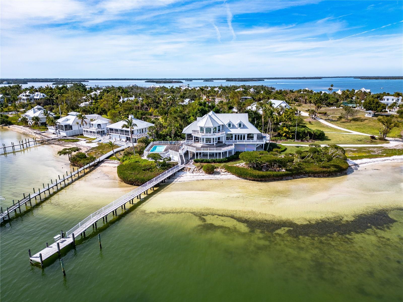 Located on the eastern shore of the reimagined and redeveloped private Useppa Island, the Aerie estate is the signature property on 30 miles of Pine Island Sound. With 250 feet of shoreline and views that capture 180 degrees of the Sound stretching for miles, the home is unique. Enter the foyer and take in a great room reminiscent of a century old fishing retreat, the pecky cypress ceiling soaring 25 feet above the fireplace gathering area, broad windows to watch passing boats and soaring birds. A mezzanine floor overlooking the great room boasts a kitchen with two of everything and room for multiple chefs-or dishwashers or bartenders. Overlooking the water from this level is a dining room for 12. Adjacent to the kitchen is a screened-in grilling and outdoor serving area, and a swimming pool with an expansive deck area. Also on this level is a half bath, and 2 bedrooms with ensuite baths. The second floor includes 2 bedrooms with ensuite baths and a massive 25x30 owners suite. A private dock, enclosed and conditioned garage, storage and equipment rooms provide the service areas needed to serve this expansive home. Useppa has all the services and amenities of a small town, and is a bridgeless island ensuring privacy and solitude. Yet an active lifestyle of boating and sporting activities for any that wish to participate. The island is known for its outgoing community of residents, and with only 118 homes, the nature of the island will not deviate from the tropical luxury and Old Florida ambiance that create this special place in the sun.