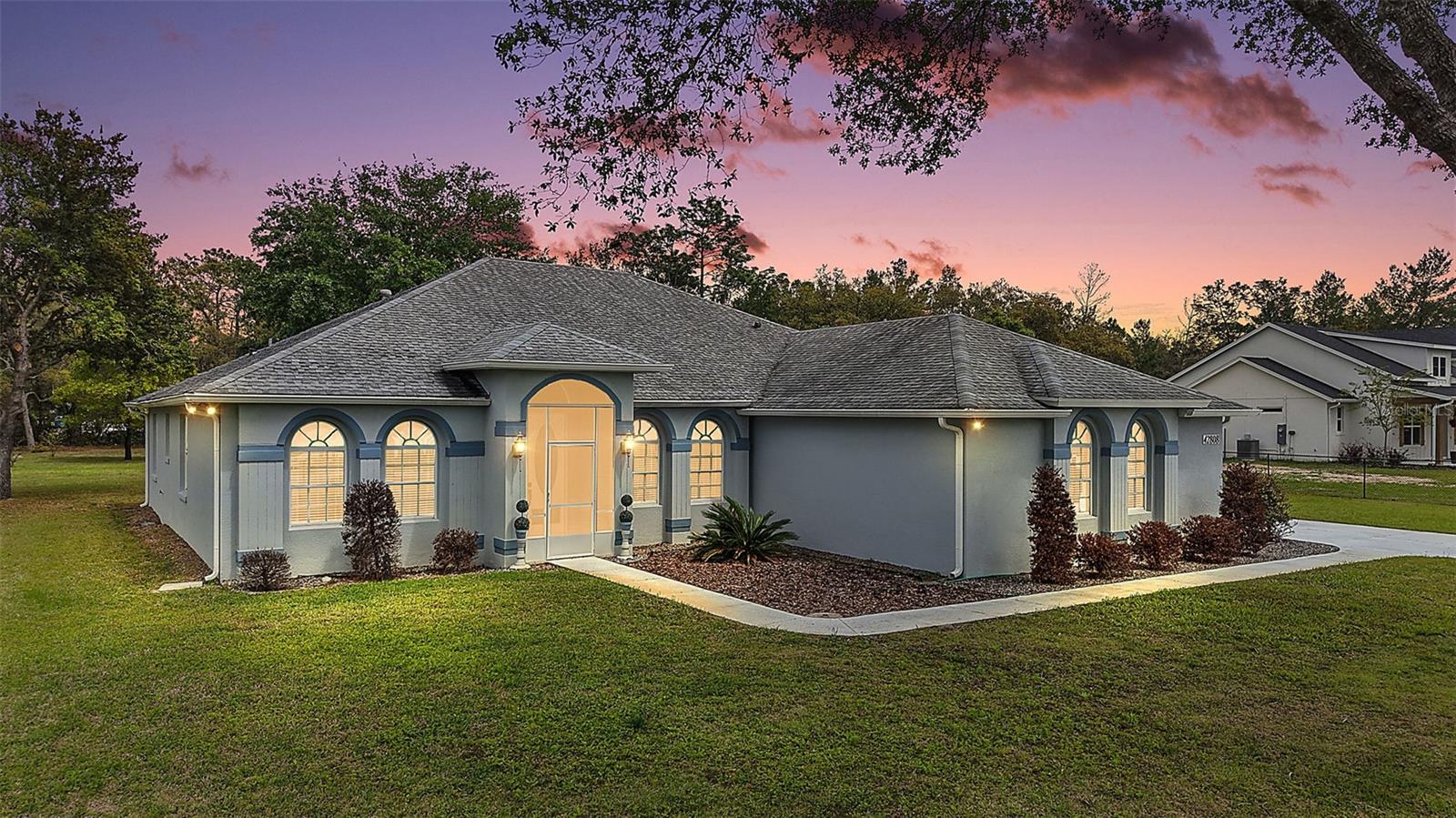 One or more photo(s) has been virtually staged. Welcome to your own PRIVATE RETREAT in this EXPANSIVE, METICULOUSLY-MAINTAINED, 3-Bedroom 3-Bath, CUSTOM, BLOCK and STUCCO home quietly nestled on a FULLY FENCED one-acre lot in the highly desirable Royal Trails subdivision, offering both SPACE and SECLUSION! ZONED FOR HORSES! A GATED property entrance, DECORATIVELY PAINTED drive and walkways, and SCREENED vestibule with ELEGANT frosted glass DOUBLE-DOOR entry, welcome you to this INCREDIBLE home! Inside, you’ll find DIAGONAL TILE flooring and impressive, soaring HIGH 10’ CEILINGS adorned with CROWN MOLDING. A generous foyer is framed by formal living and dining rooms each featuring DOUBLE windows topped with arched transoms, filling the spaces with NATURAL LIGHT and architectural charm. The inviting 20’x17’ family room, is the centerpiece of the home, offering a COZY CORNER FIREPLACE with brick hearth, two ceiling fans, and four-panel French doors that open to the SPACIOUS screened lanai with extended PAVER patio—perfect for indoor-outdoor living. The well-appointed kitchen is designed for both function and style, featuring 42” STAGGERED, MAPLE cabinetry with ROLL-OUT shelving, under-cabinet lighting, a plate rack, and an EAT-IN breakfast bar. The adjacent dinette with WAINSCOTED walls and a BAY window offers the perfect spot for casual dining. At the opposite side of the kitchen, is a PANTRY closet and a GENEROUS 8’x7’ WALK-THRU BUTLER PANTRY that leads to an EXPANSIVE 20’x24’ BONUS ROOM featuring DOUBLE windows with arched transoms, TWO ceiling fans, attic access stairs, a CONVENIENT laundry closet with utility sink and shelving, and a set of exterior French doors with a remote-controlled awning leading to the driveway. The primary suite is a true retreat, offering French doors to the lanai and TWO CUSTOM WALK-IN closets. The luxurious en-suite bath includes a WALK-IN TILED shower, corner SOAKING TUB, MAPLE cabinetry with DUAL-sinks, LINEN closet, and a private water closet. A SPLIT FLOOR PLAN provides exceptional PRIVCY with two additional bedrooms offering large windows and built-in closets. The second bathroom includes a MAPLE vanity, TILED tub and shower combination, and a convenient hall LINEN closet. A detached two-car garage with FULL bathroom, air conditioning, and side entry offers 484 square feet of ADDITIONAL space. There are also TWO carports and THREE sheds—two of which are air-conditioned— providing ENDLESS POSSIBILITIES for parking, storage, hobbies, and workspace! ADDITIONAL FEATURES include a Guardian GENERATOR for added peace of mind. DON'T MISS YOUR OPPORTUNITY to make this AMAZING HOME YOUR OWN! If you’ve been dreaming of space, privacy, and a place to unwind, THIS PROPERTY HAS IT ALL—plenty of room to live, play, and enjoy Florida’s natural beauty! PLEASE WATCH OUR WALKTHROUGH VIDEO of this INCREDIBLE HOME and call today to schedule your Private Showing or Virtual Tour!