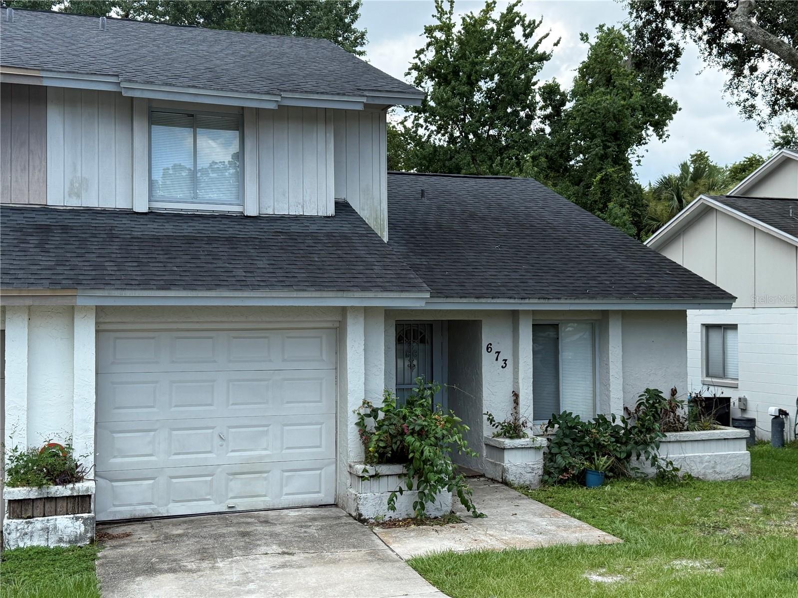 Welcome Home to your 3/2 half duplex located at the end of a cul-de-sac street with no rear neighbors.  This home features and open floor plan with the living/dining room and pass through window into the eat in kitchen as well as the popular split floor plan that has the primary bedroom on the first floor and the other two bedrooms and one bathroom upstairs.  The attached, over-sized one car garage has plenty of room for storage and a car as well as hosts the laundry hook ups.  Roof is 5 years old.