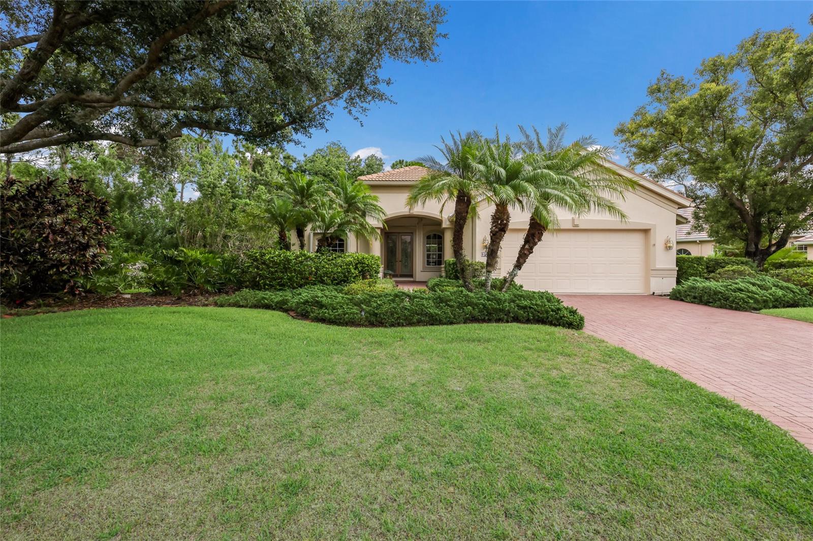 One or more photo(s) has been virtually staged. Welcome to this beautifully maintained Lee Wetherington home, offering 3 bedrooms, 3 baths, a private den/office with an open floor plan.  Designed with comfort and functionality in mind, this spacious split-bedroom floor plan with a first-floor primary suite, provides privacy for both owners and guests.  The primary suite offers two walk in closets, dual sinks with vanity, soaking tub and separate shower.   Inside, you'll find tile flooring, ceiling fans throughout and an abundance of natural light.  Step outside to your private pool and tranquil outdoor living area, surrounded by lush landscaping for a serene and secluded settings. Additional features include a newer tile roof, two newer HVAC systems and hurricane shutters for added peace of mind. The two-car garage offers ample storage, while the low HOA fees and gated community provide convenience and security.  Residents also have the opportunity to join the Lakewood Ranch Golf & Country Club, which offers several membership levels and an exceptional array of amenities, including four championship golf courses, three restaurants, pickleball, tennis aquatics facilities and a state-of-art fitness center.