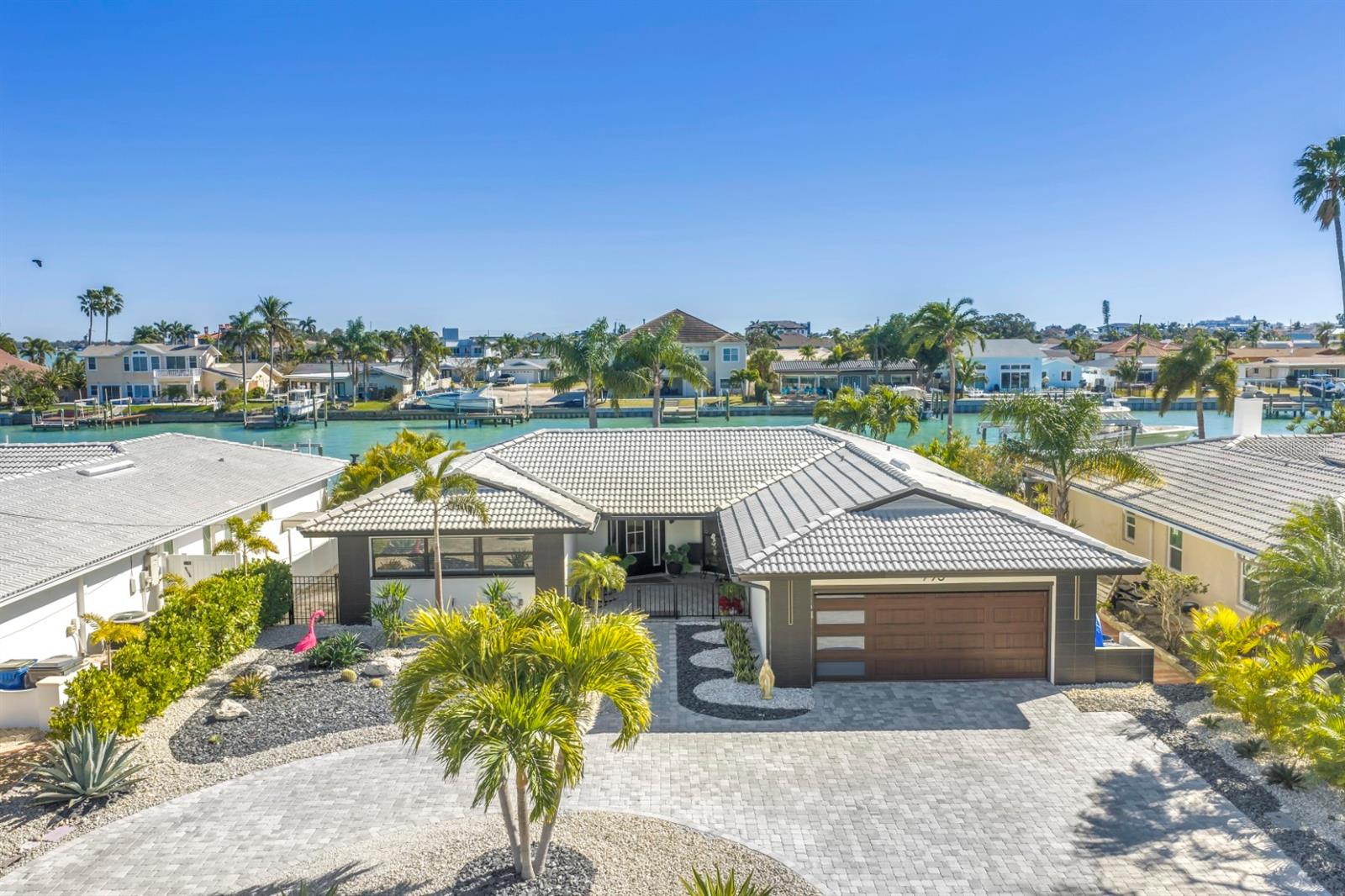 Beautifully renovated from top to bottom in 2025, this 3-bedroom, 2-bath expanded open floorplan ranch offers gorgeous, sweeping water views. New HVAC, appliances, stone floors, custom cabinetry, fully renovated bathrooms, custom closets, a private office, and a garage with epoxy flooring and extra storage. Enjoy outdoor living on the water with a stone patio and driveway, plus a brand-new dock. Nothing overlooked and nothing to do but move right in.  Perfectly positioned in Treasure Island's Isle of Capri, this home offers easy golf-cart access to everything that the World-Famous Beaches and the island offer, including waterfront dining, award-winning restaurants, parks, and year-round events. This is a rare opportunity to own a meticulously upgraded waterfront home that combines modern luxury, smart-home innovation, and timeless coastal appeal.  Don't let this property pass you by.