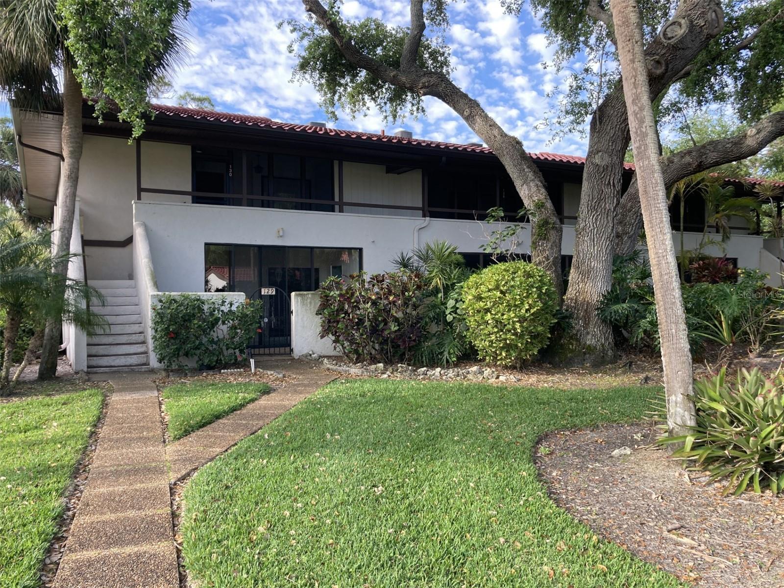 This is a first floor corner two bedroom-two bath condo in beautiful Valencia. Light and bright! New A/C in September, 2025, freshly painted and new roof in 2025. This condo has a rear and front porch which are glass enclosed, both with ceramic tile flooring. Off the back porch is a large patio and is a short distance to the heated pool and spa. The front porch has walk-in storage closet plus a walk-in laundry closet. Off the front porch is a gated courtyard, perfect for potted plants and out door seating. Located in the IMG Country Club area, which features an 18 hole regulation golf course and a beautiful clubhouse located on Sarasota Bay - both open to the public.  There is also a tennis club a few blocks away. There is plenty of shopping near by - groceries, Target, pet stores, etc and a great selection of restaurants.  About 15 minutes to the airport and Sarasota.  About 8 miles to the beach.