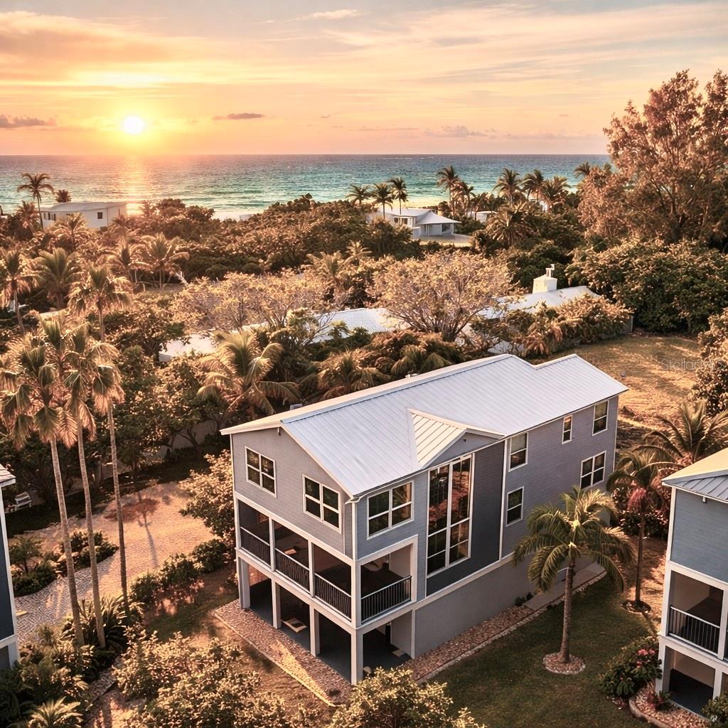 Modern Beach Home priced aggressively to sell as the owners are relocating. Ocean Views! Private Dock With Boat Lift On The Bay!  Exclusive Beach Community, The Ultimate Beach lifestyle! This raised (16ft.), three bedroom (possible 4th), three bath, three plus car garage home is situated perfectly between the gulf and bay. The exclusive, gated community of Laguna Yacht Village is Longboat Key's best kept secret, consisting of only 8 homes on 9 lots. This quiet, private beach and boating development is unmatched! Relax on your deck, on your boat, at the beach or by the private heated and chilled pool in the knowledge that all the grounds, pool and dock infrastructure are maintained by the HOA.   The home has been thoroughly modernized and expanded in 2019/2020 by the current owners. New 25 year aluminum roof, pre-painted hardiplank exterior, enclosed upper deck expanded Master Suite, complete bathroom and kitchen renovations, new water heater (2025), 5 ton HVAC, washer, dryer and kitchen appliances (Sub Zero and Bosch) as well as refinished hardwood floors on the main level and newly laid matching hardwood floors throughout the entire upstairs make this effectively a totally new home. Whilst not required by the current owners, the upstairs loft area could easily be converted into a 4th bedroom. The majority of the work was accomplished by Greyhawk of Bradenton. Other lavish touches include new solid panel doors, new 16 feet wide opening glass slider doors, integrated 180 bottle wine fridge, an oversized 3 plus car garage including new door and the installation of a 10,000 lb boat lift at the deeded private dock. Call today to schedule your private Viewing.