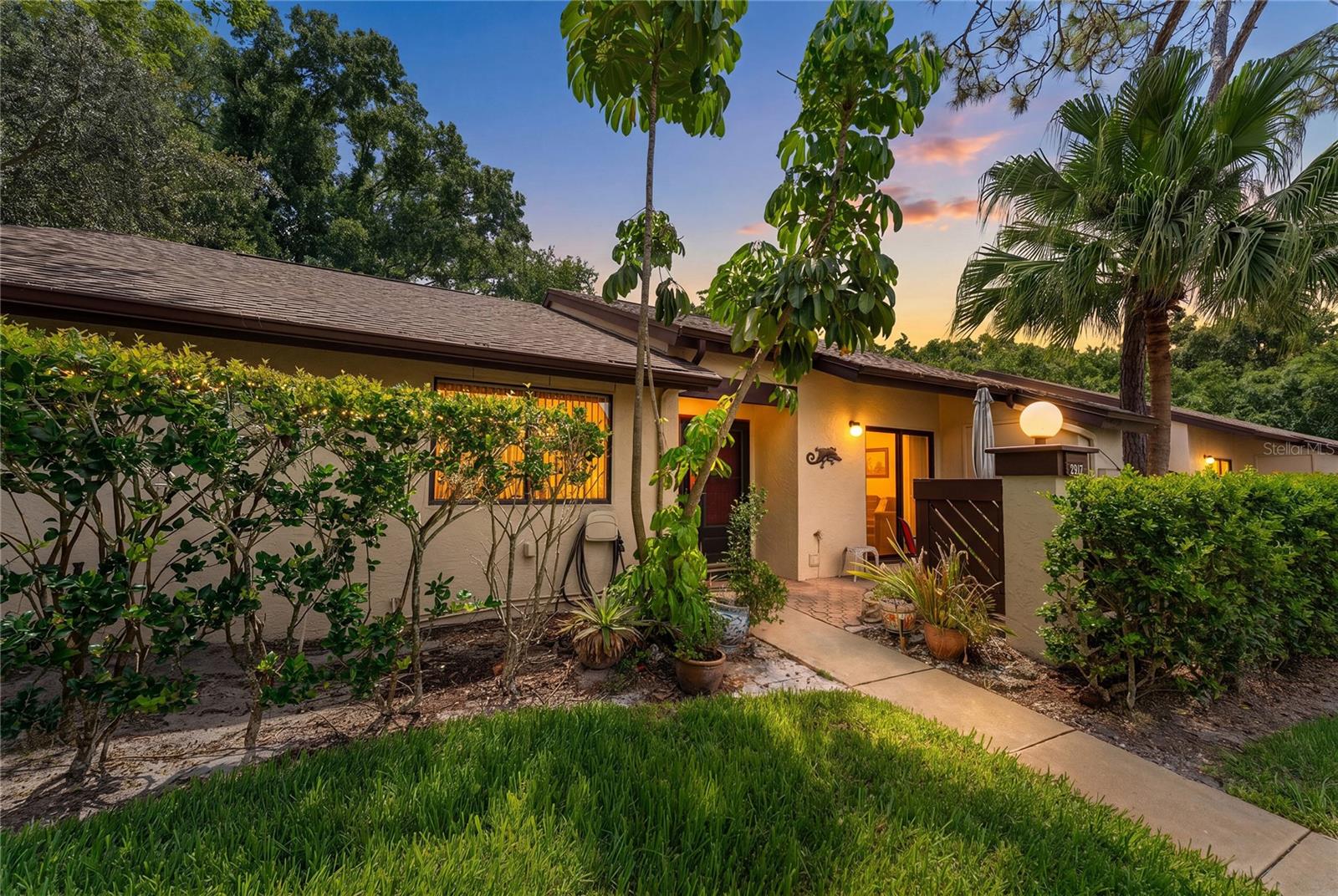 Welcome to 2917 Fig Court, a charming single-story villa offering 3 bedrooms, 2 bathrooms, and an abundance of comfortable living space in a peaceful Palm Harbor setting. As you approach the home, you'll be greeted by a private courtyard, the perfect spot to enjoy your morning coffee, host a barbecue, or simply unwind outdoors.

Step inside to a welcoming foyer that opens to a spacious living room featuring beautiful wood flooring and plenty of room for both everyday living and entertaining. The thoughtfully designed floor plan provides a seamless flow throughout the home. The generously sized primary suite offers both a walk-in closet and an additional closet, providing ample storage. Both the primary bedroom and secondary bedroom feature direct access to the rear patio, creating an inviting connection to the outdoors.

The tranquil back patio overlooks a lush conservation area, offering privacy and a peaceful backdrop to enjoy Florida's beautiful weather year-round. As a desirable corner unit, this villa provides added privacy and a quiet atmosphere, making it an ideal place to call home. Conveniently located near shopping, dining, parks, and Gulf Coast beaches, this home combines comfort, charm, and an exceptional location.