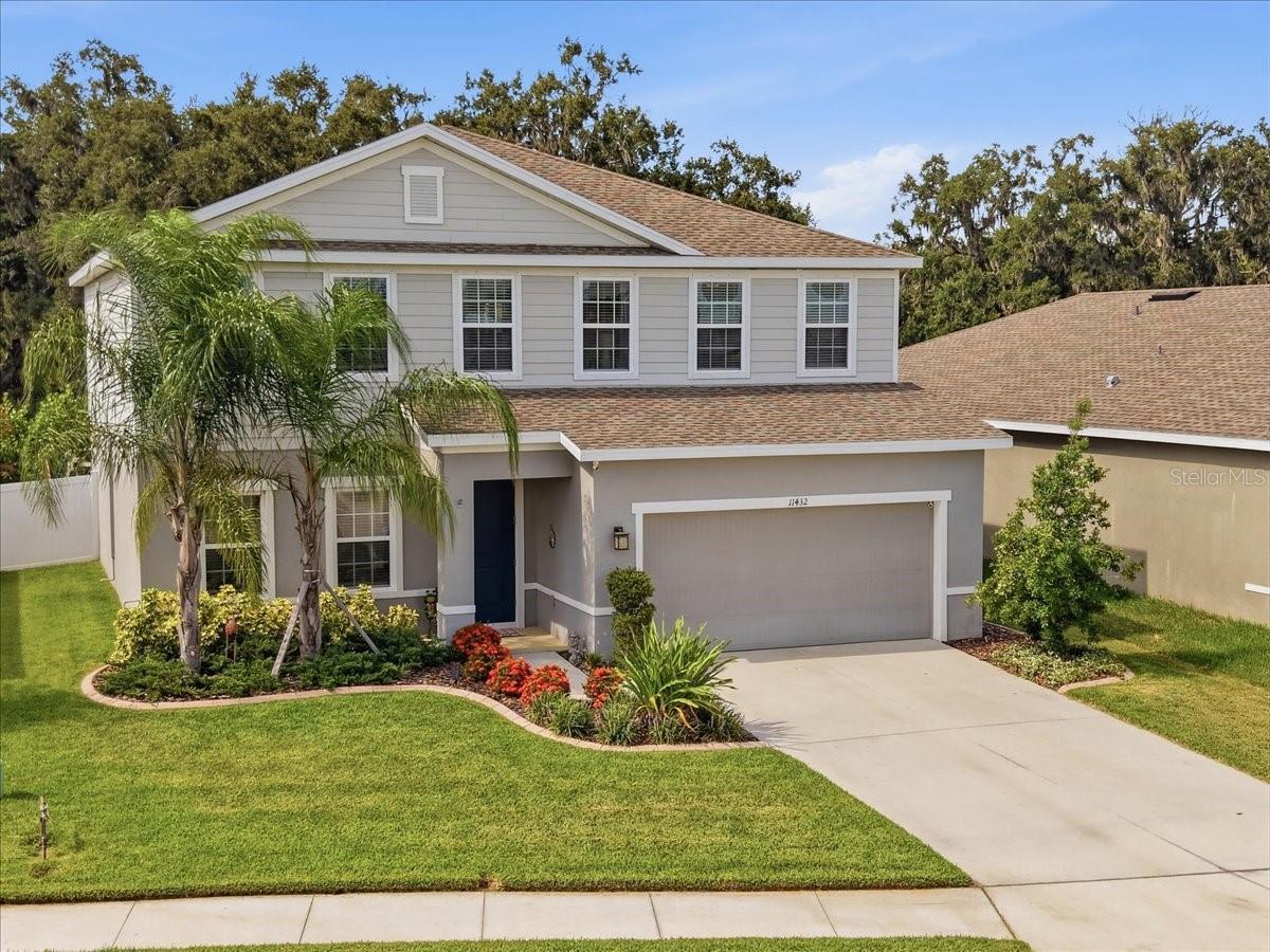 Room to breathe. Space to grow. Privacy to enjoy. 11432 64th Street East is a 4-bedroom, 2.5-bath, two-story home in Parrish, Florida offering over 3,100 square feet of thoughtfully designed living space, a 2-car garage, a dedicated home office, an upstairs bonus family room, and a screened lanai backing to a private backyard with no rear neighbors. This is the kind of home that families search months to find, and it is available right now.

The main floor sets the tone immediately. The open-concept living and dining areas are bright, generous, and connected seamlessly to a well-appointed kitchen featuring granite countertops, white cabinetry, a large center island with seating, a mosaic tile backsplash, stainless steel appliances, a pantry, and pendant lighting overhead. The layout flows naturally from kitchen to dining to living, making everyday life and entertaining equally effortless. A dedicated home office on the first floor provides a private, quiet workspace completely separate from the main living areas. A half bath and covered entry complete the ground floor.

Upstairs, the primary suite is a genuine retreat. The bedroom is oversized at nearly 21 by 14 feet, and the ensuite bath delivers a spa experience with dual vanities, a soaking tub, and a separate walk-in shower. Two walk-in closets provide exceptional storage. Three additional well-proportioned guest bedrooms each offer good natural light and generous closet space. A spacious upstairs bonus family room adds flexible living space perfect for a playroom, media room, or teen retreat. The upstairs laundry room is conveniently located exactly where laundry actually happens.

Step through the sliding glass doors and the screened lanai extends the living space into the Florida outdoors. The backyard is private and peaceful, with no rear neighbors and plenty of room to add a pool.

Parrish is one of the fastest-growing and most desirable communities on Florida's Gulf Coast. Conveniently positioned between Sarasota, Bradenton, St. Petersburg, and Tampa with quick access to I-75, residents enjoy top-rated schools, parks, shopping, dining, and some of the best beaches in the state all within a short drive.

11432 64th Street East · Parrish FL 34219 · Manatee County