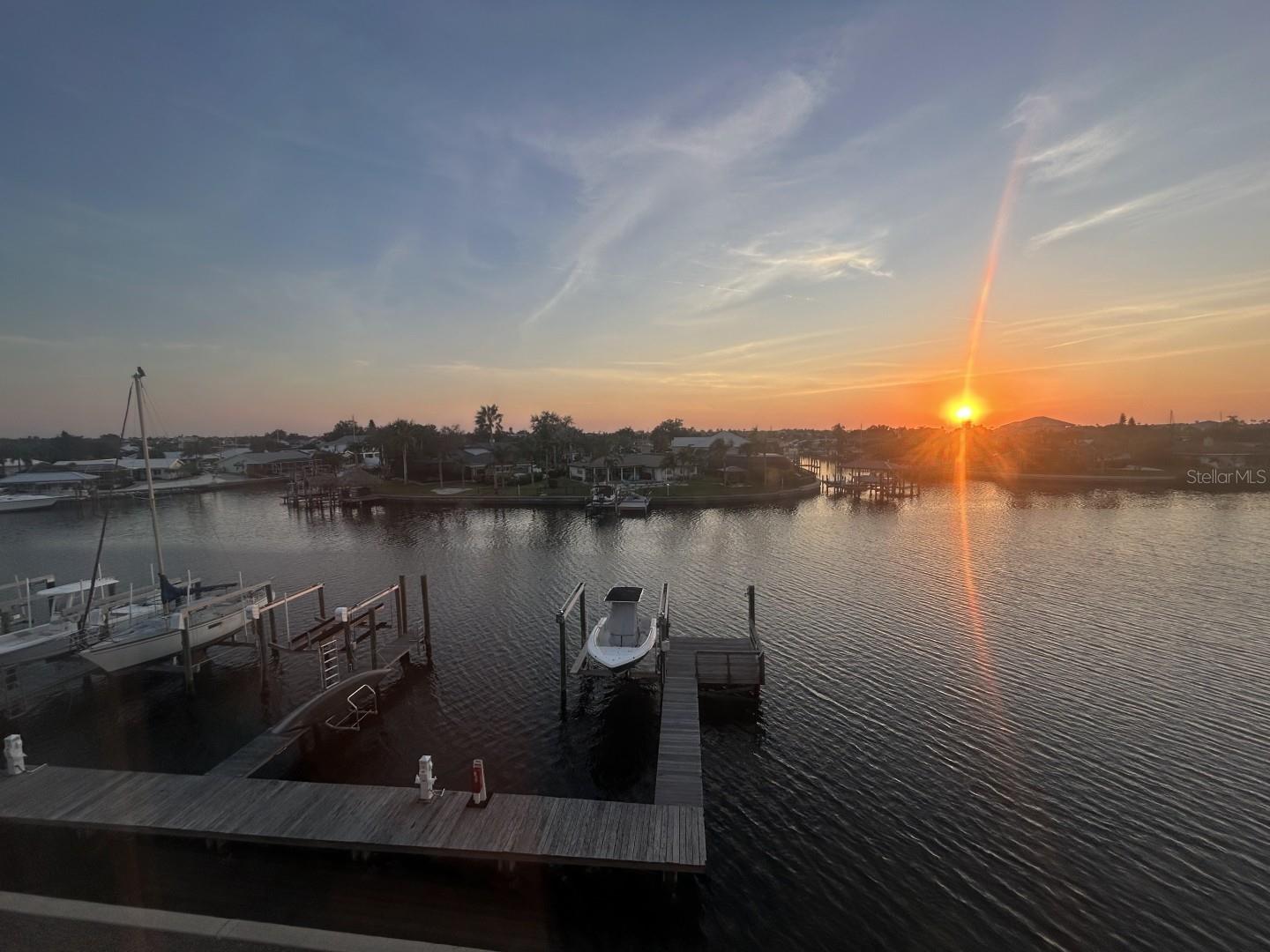It's time to make your wishes come true with elevated coastal living in this exceptional 4-story waterfront townhome offering 2,850 square feet, 3 bedrooms, 3.5 bathrooms, a 3-car tandem garage and private dock....for viewing magnificent sunsets every evening, spectacular views of Bal Harbor and Tampa Bay, minutes to Tampa Bay via your boat, a private dock with water, electric and a 10,000 lb. boat lift making fishing, boating and sailing right at your doorstep for hassle free boating adventures.  Fire up your grill while watching boaters, birds and dolphins from your back lanai or walk down to Circles or Finns restaurants for those special family events.  The second story has your family room, dining room and kitchen all blended for a perfect entertainment center including the screened lanai overlooking the waterfront. The upscale kitchen stands out with stainless steel appliances, granite counters and all wood cabinets.  This family gathering center makes this a true family retreat mecca.  The first guest bedroom with lagoon view and ensuite bath and walk-in closet is also located on this floor as is the guest half bath.  Moving up to the third floor is the second guest bedroom with lagoon view and ensuite bath and walk-in closet.  The laundry center is conveniently located down the hall.  Next, the waterfront view owner's suite, which includes a cozy lanai perfect for morning coffee or evening sunset watching, makes this property an extraordinary find.  The ensuite bath has double sinks, spacious walk-in shower and a jacuzzi garden tub for true relaxation as well as a spacious walk-in closet.  The fourth floor has a spacious bonus room with stellar views of Tampa Bay and St. Pete. This flexible room can be used as a game room, media room, office or for extra sleeping acommodations.  All floors are accessible via steps or via your private elevator.  Come see this perfect waterfront townhome, with maintenance free living so you can enjoy all the amenities this property offers.