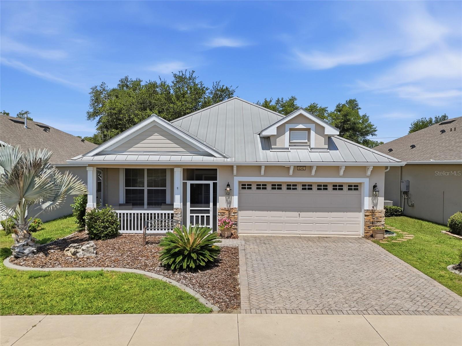 Set within The Cottages of Sanders Grove, a gated 55+ community in Okahumpka, this single-story home offers comfortable Florida living with a
welcoming front porch, practical split-bedroom layout, and a large screened rear porch for enjoying the outdoors. Inside, the 3-bedroom, 2-bath
floor plan includes 1,788 square feet of heated living space with high ceilings, tile flooring through the main living areas, and carpeted bedrooms.
The living and dining areas flow together easily, creating a central gathering space that connects naturally to the kitchen and rear porch. The
kitchen features Corian countertops, stainless steel appliances, a breakfast bar, closet pantry, and a casual dining area with French doors leading
outside. The primary suite is tucked away from the secondary bedrooms and includes an en suite bath with dual sinks, a walk-in shower, and a
private toilet area. Two additional bedrooms share a full bath with a tub/shower combination, offering flexibility for guests, hobbies, or everyday
needs. Additional highlights include a 2025 HVAC system, interior laundry room, attached two-car garage, and screened lanai overlooking the
backyard. Residents of The Cottages of Sanders Grove enjoy access to a clubhouse with seating areas, multipurpose space, a library, fitness
center, walking trails, paths, community water views, and proximity to Lake County boat ramps, parks, greenspaces, Leesburg, and The Villages.