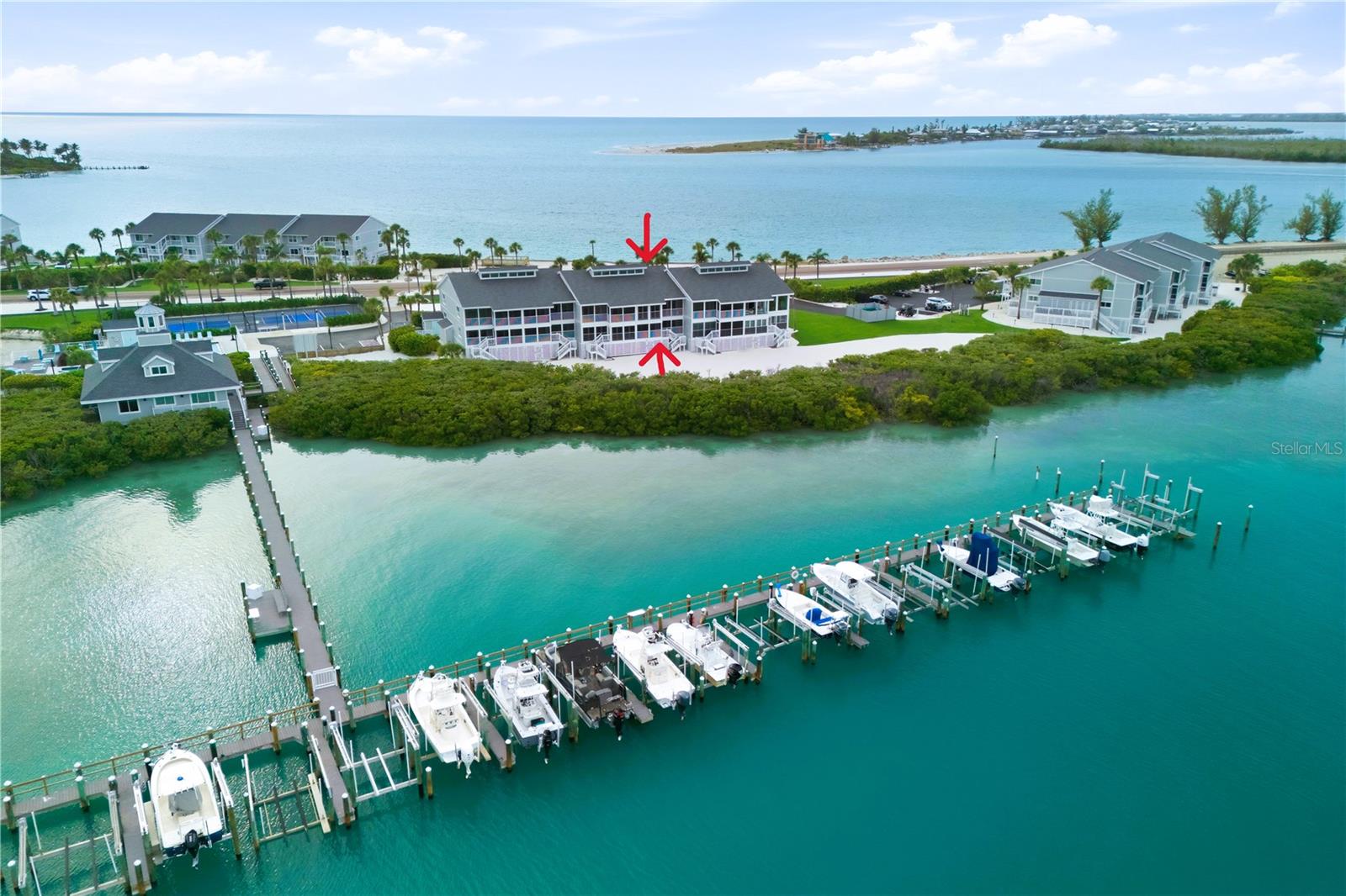 One or more photo(s) has been virtually staged. Some island properties are easy to understand from photos. Others reveal their value the moment you step inside. Boca Grande North Unit B21 is one of those residences—renovated, flexible, beautifully positioned, and offering far more usable space than buyers may expect in a Boca Grande condominium.  Here, you do not have to choose between sunrise over the Bay and sunset over the Gulf. This beautifully renovated three-bedroom, three-bath residence with den/office captures both perspectives, creating a coastal living experience that feels connected to the water throughout the day. Inside, volume ceilings, impact windows and sliders, luxury vinyl flooring, updated finishes, and a thoughtful two-level layout give the home a sense of openness, comfort, and versatility that sets it apart. The main living level offers an open-concept kitchen, comfortable living and dining areas, two bedrooms, two full bathrooms, and a private front lanai that extends the living experience outdoors. It is easy to picture slow mornings, island weekends, extended stays, and effortless hosting in a space designed to live comfortably.  The bonus second level is the feature buyers will remember. Upstairs, an additional bedroom, full bathroom, and den/office create valuable separation for guests, family, remote work, hobbies, or quiet retreat space. This added flexibility makes Unit B21 feel less like a standard condo and more like a true island residence with room to adapt. Boca Grande North is a gated waterfront community offering a heated pool and spa, tennis/pickleball, kayak launch, fishing, boat docks when available, and private beach access across the road. Minutes from the village of Boca Grande, Gulf beaches, boating, restaurants, and shops, this location delivers the ease of island living with the amenities buyers want most.  For buyers who have been searching for a Boca Grande residence that offers more than the expected, Unit B21 deserves to be seen in person. The photos introduce the views, the renovation, and the coastal setting—but the walk-through is where the value becomes clear. The extra bedroom, full bath, den/office, volume ceilings, and Bay-to-Gulf perspective come together in a way that feels larger, smarter, and more livable than a typical island condominium. This is the one buyers will understand the moment they step inside.