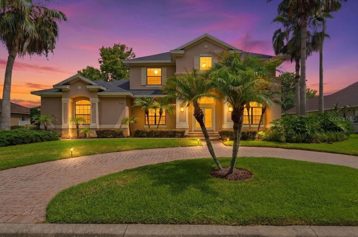 Welcome to Highlands by the Lake, one of Southeast Lakeland's most sought-after communities. This exceptional custom-built 5-bedroom, 4-bath home offers the perfect blend of elegance, comfort, and Florida lifestyle living.

Designed for both everyday living and entertaining, the open-concept floor plan features a spacious great room, formal dining room, dedicated office/fifth bedroom, and a first-floor owner's suite. The gourmet kitchen is a chef's dream with a propane cooktop, wall oven, built-in microwave, island prep sink, abundant custom cabinetry, and a bright breakfast area. Italian hardwood flooring and porcelain tile add warmth and sophistication throughout the main living spaces.

A striking custom iron staircase leads upstairs to a large loft and game room overlooking the great room below, along with three additional bedrooms, two full baths, and a hidden bonus room perfect for a media room, playroom, fitness space, or private retreat.

Step outside to your own backyard oasis featuring a custom gazebo, pergola, brick paver patio, screened lanai plumbed for a future summer kitchen, mature fruit trees, and a twelve-foot privacy hedge. The oversized side-entry three-car garage provides exceptional storage and flexibility.

Residents enjoy access to a community clubhouse, pool, tennis courts, and convenient access to Banana Lake's public boat ramp for boating, fishing, skiing, and year-round outdoor recreation.

More than just a house, this is a home designed for gathering, entertaining, and making memories for years to come.

*5th bedroom currently used as an office, includes closet.
*Propane gas cooktop runs off a buried propane tank leased from AmeriGas, not owned. Tank doesn't convey, buyer would take over or set up their own AmeriGas account.