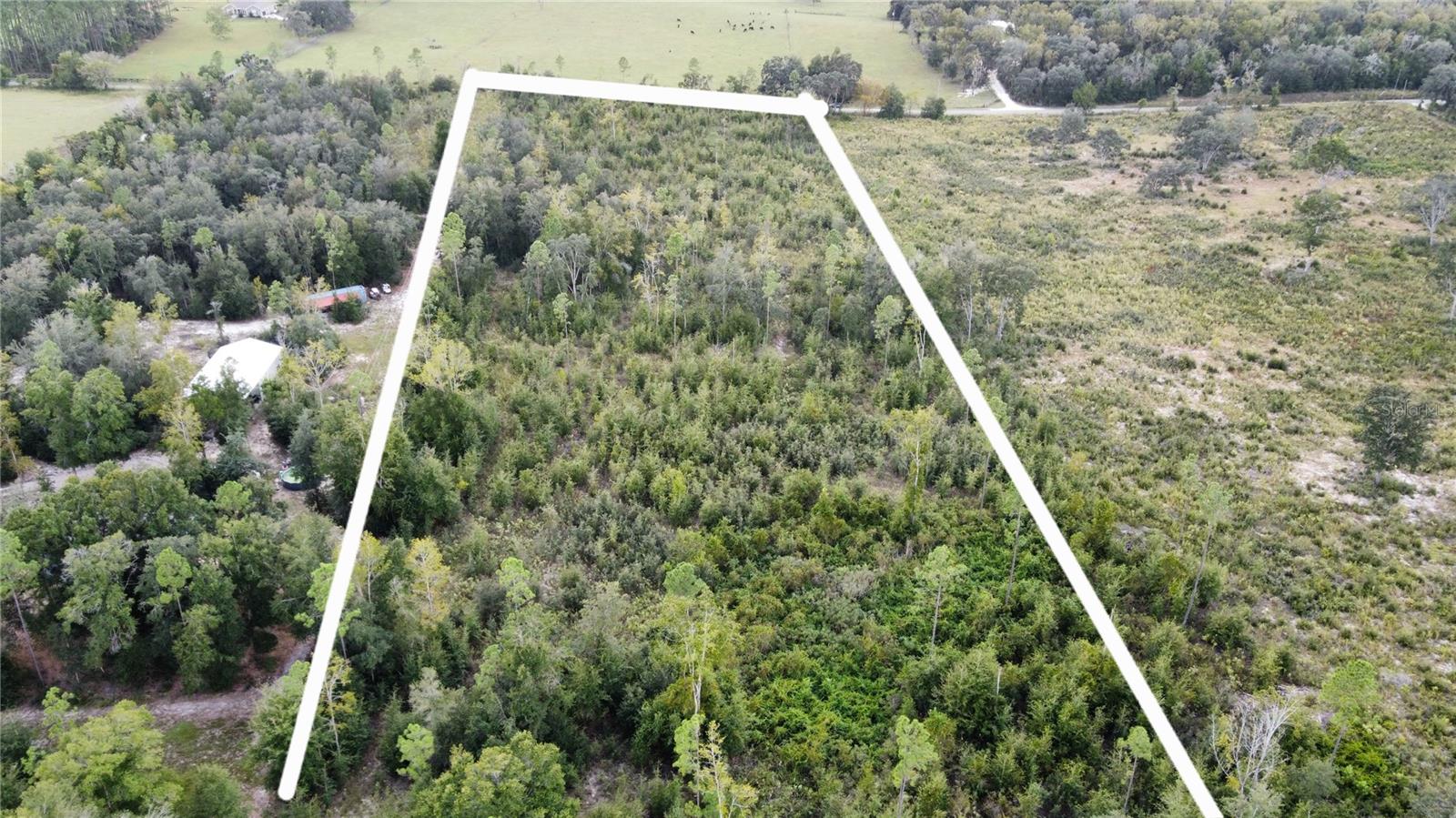 9.96 acres of beautiful vacant land in a private secluded setting for your new home or to hold as agriculture zoned land. There is a New mobile home and large new metal barn on the property next door for sale. This would make a 20 acre parcel if interested.  Many families in this area hold large parcels surrounding this property just outside of Newberry, Fl.  Picturesque views surround this private gem. You can place a new mobile home or a site built home on this land. No deed restrictions. Bring your animals and family to this quiet peaceful retreat just outside of town. Please go see this mature, wooded lot for your new paradise today!