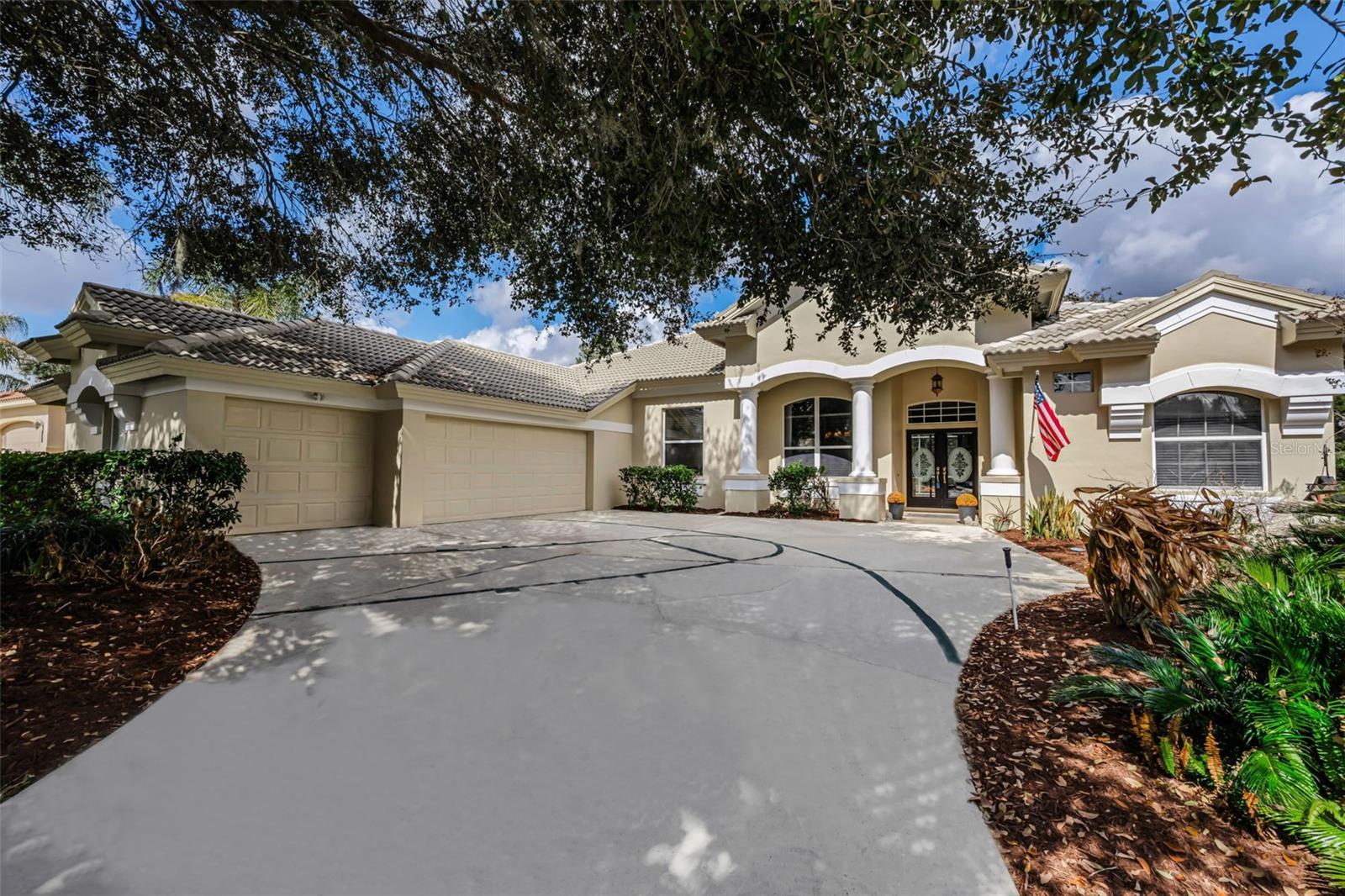 Home is available for purchase or rent! Experience elevated Florida living in this stunning Mark Maconi custom-designed home, located in the prestigious, gated Lake Jovita Golf & Country Club community. Nestled on a quiet cul-de-sac and overlooking the 8th hole of Lake Jovita’s South Course, this pool and spa home offers nearly 3,000 square feet of refined living space with breathtaking golf course views. From the moment you arrive, the home impresses with exceptional curb appeal highlighted by double entry doors and a rare courtyard-style three-car garage. Inside, soaring ceilings and abundant natural light complement the seamless blend of tile and wood flooring throughout, no carpet, creating a warm yet sophisticated atmosphere. Designed for both entertaining and everyday comfort, the open-concept floor plan centers around a striking double-sided fireplace visible from multiple living areas. The traditional gourmet kitchen is  features solid-surface countertops, stainless steel appliances, a center island, breakfast bar seating, walk-in pantry, and ample cabinetry, perfect for hosting gatherings or enjoying casual meals. A spacious laundry room and convenient garage-entry drop zone with built-in desk and storage add everyday practicality. A versatile office/flex room with a closet near the main living area offers endless possibilities as a home office, media room, or optional fifth bedroom. The owner’s suite is a true retreat, showcasing double tray ceilings and a luxurious spa-inspired bath with soaking tub, dual vanities, granite countertops, walk-in shower, and generous closets. The classic Florida split-bedroom floor plan provides privacy and comfort for family and guests alike. Two bedrooms are tucked behind the kitchen, while a fourth bedroom off the family room features a full bath with walk-in shower and direct pool access, making it ideal for guests or multigenerational living. Step outside to your private outdoor oasis where a spacious screened lanai, resort-style pool, and spa overlook tranquil golf course scenery, perfect for year-round entertaining or relaxing under the Florida sun and stars. Lake Jovita offers an exceptional lifestyle with two championship 18-hole golf courses, a community park with dog run, basketball and pickleball courts, and optional memberships to tennis, fitness center, club pool, dining, and social events. Enjoy low HOA fees, no CDD, and a prime location just 5 minutes to I-75 and approximately 35 minutes north of Tampa, providing easy access to shopping, dining, and major employment centers. This remarkable Lake Jovita golf course pool home presents a rare opportunity to own a luxury residence that you can make your own combining privacy, scenic views, and exceptional community amenities. Schedule your private showing today!