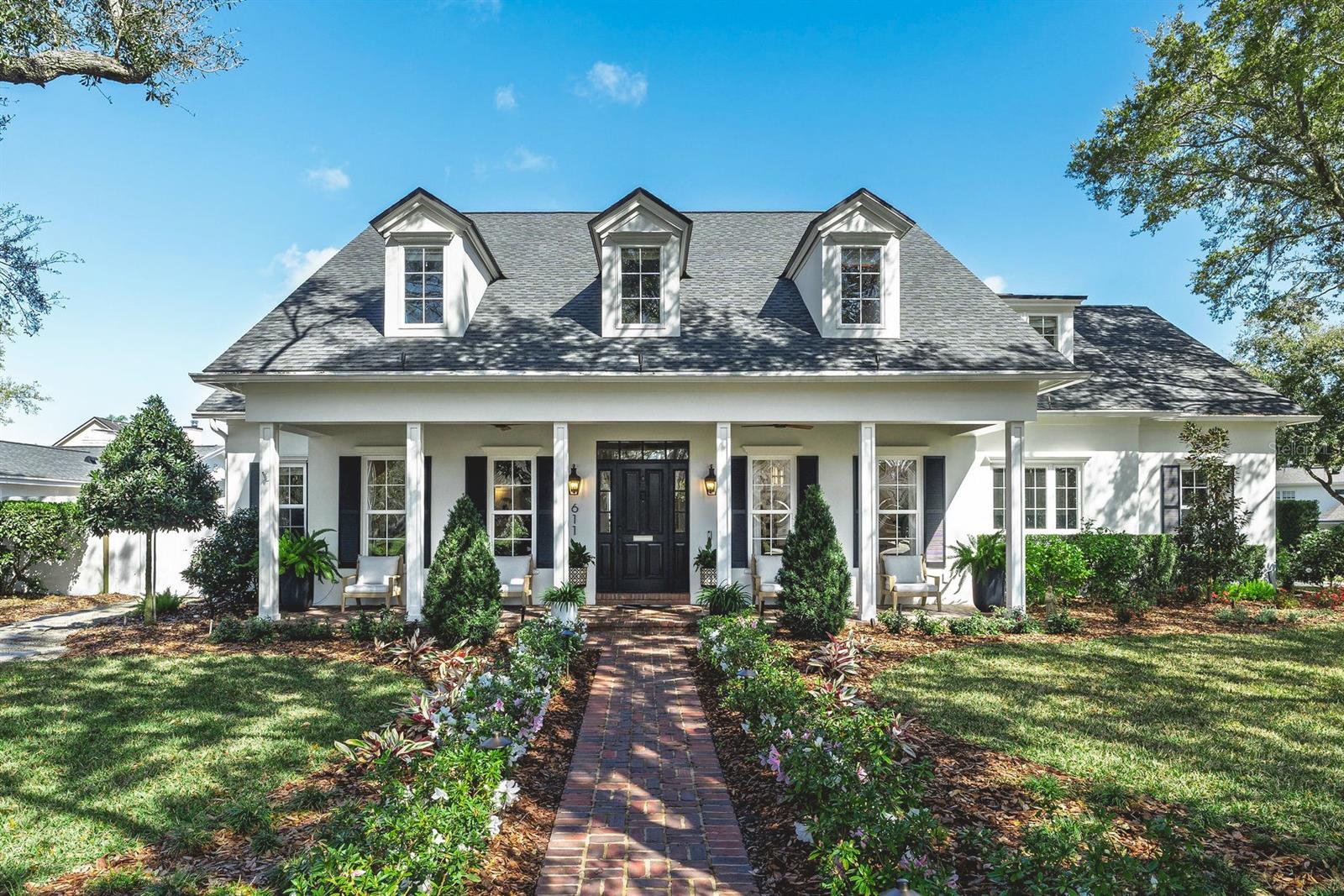 Artistry and exquisite style are brilliantly showcased in this renovated Winter Park masterpiece. Located in the coveted neighborhood of Park Grove, this magical home is sure to take your breath away, with stunning surprises around every corner. Since 2022, the home has undergone an extraordinary transformation in thoughtful renovations, upgrades, and enhancements throughout. Highlights include refinished and new hardwood floors extended across the entire first floor and continued onto the second level with sound-reducing underlayment, renovated bathrooms with designer plumbing fixtures, and new door hardware throughout for a cohesive, high-end finish. A dramatic 16-foot sliding glass door was added by removing the former wall, opening the living spaces to the outdoors with a sleek modern system. Elevated by designer lighting, sophisticated wall coverings, and custom window treatments, the thoughtful floor plan leaves nothing to be desired. At the center of the home, the open family room seamlessly converges with a polished kitchen, separated by an expansive breakfast bar. Sub-Zero, Wolf, and Bosch stainless steel appliances, including a gas cooktop and built-in dual convection ovens, surround a separate prep island. A sun-filled dinette with pool views sits at the far end. Ample storage, a walk-in pantry, built-in workstation, and wet bar/butler’s area with icemaker enhance functionality and entertaining. Lounge or dine beneath two covered lanai areas with electronic screens, or enjoy the newly redesigned & resurfaced pool and deck completed in 2023. Improvements include an expansive sun shelf with bubbler and umbrella sleeve, conversion to a saltwater system, and updated marble pool deck, all surrounded by a newer vinyl fence and block walls lined with tall hedges for privacy. Defined front living and dining rooms feature floor-to-ceiling windows with custom window treatments, while a perfectly placed powder room and coat closet are off the grand foyer. The spacious laundry room, with a laundry chute, is bursting with natural sunlight. The floor plan further enhances functionality with a downstairs Primary Suite featuring French doors that provide direct access to both covered lanais and the backyard. The newly renovated primary bath offers an LED-lit glass shower, soaking tub beneath a window, water closet, and large custom boutique-style walk-in closet. Tucked behind the dinette is the secondary guest bedroom wing currently used as a private office, with French doors, and a renovated full bath accessible from the pool deck. Upstairs features three large bedrooms, two full bathrooms, and a gym equipped with a built-in mini fridge, all centered around an enormous bonus room with built-in cabinetry. The oversized side-facing two-car garage sits off Summerland Avenue’s charming brick street and includes epoxy floors, workshop space or room for bikes & strollers, a second refrigerator, storage cabinets, and extensive hanging storage. The westside lawn was designed with a trellis over the garden area, perfect for homegrown produce. The garden area includes dedicated irrigation lines that feed from the well irrigation system. Other luxury elevated features include a home audio system (inside and out), a whole-house generator, whole-home water filtration system, and integrated security system with hard-wired cameras. This home truly has it all.