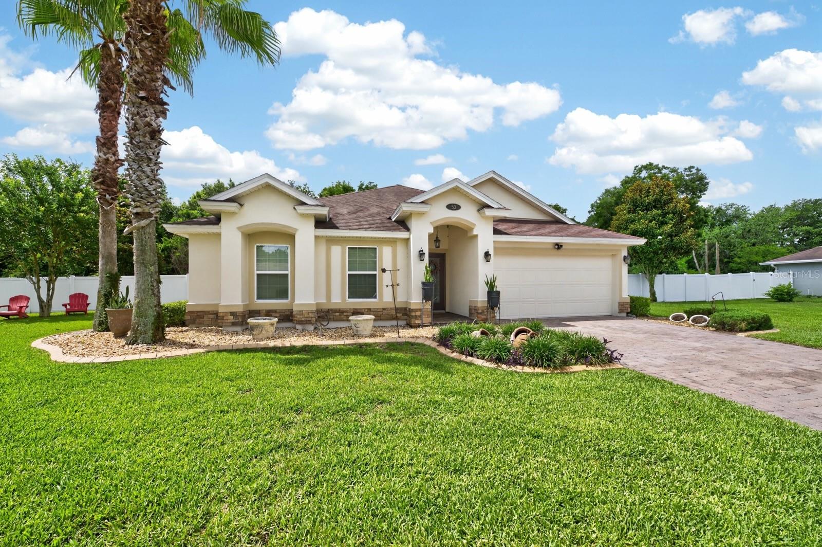 Imagine coming home each day to peaceful wooded views, a quiet cul-de-sac setting, and the comfort of a meticulously maintained home designed for the way you live. Welcome to 53 Auberry Drive, where thoughtful design, quality updates, and an exceptional outdoor setting come together to create a truly special opportunity in Palm Coast.  Situated on an oversized homesite backing to a wooded preserve and canal, this three-bedroom, two-bath residence offers 1,868 square feet of well-planned living space with room to relax, entertain, and enjoy life both indoors and out. The attractive split-bedroom layout provides privacy for family members and guests while maintaining an open, connected feel throughout the main living areas.  The kitchen serves as the centerpiece of the home, featuring stainless steel appliances, a gas range for cooking enthusiasts, a spacious center island, and an abundance of storage including a large pantry. Whether you're preparing a gourmet dinner or gathering with friends and family, this inviting space effortlessly accommodates every occasion.  The primary suite offers a peaceful retreat at the end of the day with elegant tray ceilings and generous walk-in closets. The secondary bedrooms provide versatility, with the oversized second bedroom offering incredible potential as a guest retreat, home office, hobby room, or additional primary suite.  Outside, the property truly shines. The expansive backyard invites endless possibilities for outdoor enjoyment. Mature surroundings create a serene atmosphere while the canal and wooded backdrop enhance privacy and natural beauty. A dedicated gardening area provides the perfect space to cultivate flowers, herbs, or vegetables. Vinyl fencing and decorative curbing add both charm and functionality, creating a polished outdoor environment that is ready to enjoy.  Practical improvements include an updated air conditioning system installed in 2023 and an epoxy-coated two-car garage floor that adds durability and style.  Living in Palm Coast means embracing an active and vibrant lifestyle. Spend your days golfing, playing tennis, exploring miles of walking and biking trails, or relaxing at nearby beaches along Florida's stunning Atlantic coast. Convenient access to shopping, dining, healthcare facilities, and major destinations including St. Augustine, Daytona Beach, and Jacksonville makes everyday living easy and enjoyable.  Rarely does a home have this combination of privacy, location, flexible living space, and outdoor appeal. Discover the lifestyle you've been waiting for at 53 Auberry Drive and experience all that this exceptional property provides.