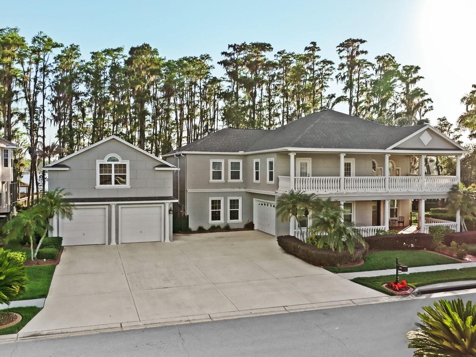 Amazing waterfront property on 162 acre ski Lake Thomas with covered motorized boat lift and two motorized jet ski lifts! Two story executive home with 5 bedrooms / 7.5 baths and 4+ car garage. Interior features cathedral ceiling entranceway with soaring ceilings, separate formal living and dining rooms with oak flooring. Family room includes custom built-in entertainment center and French doors to the rear patio area. Chef’s kitchen features granite counters, solid wood cabinetry, gas cooktop, double refrigerator, and prep island with sink. Fantastic views of the lake from the kitchen and dinette. First floor also includes large game room with wet bar, built-in cabinets, granite counter, bar seating area and French doors to pool area. Second floor features  large open loft space with built-in shelves and desk, perfect for play or study area. Grand primary bedroom is a true escape with wood floors, built-in shelving large connecting office/flex/tv room space. Three of the four additional upstairs bedrooms have en-suite baths while there is also an additional full hallway bathroom. Attached oversized 2 car garage with dedicated generator plug in, as well as additional oversized 2 car garage detached. Detached garage also features a separate upstairs apartment/bonus room with full bath. Over 700 sqft upstairs space with room for small kitchen. Resort style pool area features include, sun shelf, pebble tech finish, gas heater for pool and spa, hard covered gazebo area is excellent for grilling or relaxing by the pool in the shade. Dock includes motorized boat and jet ski lifts, electric service, water spigot, sun deck and covered decking for relaxing or entertaining on the water. Sunsets are spectacular with dock facing west/southwest. Lot is just shy of 1 acre with timber sea wall, wrought iron fenced side yard, and cul-de-sac street. No CDD and low HOA in this gated custom home community. A-rated schools, easy access to shopping, malls, dining and entertainment, 30 minutes from airport, close to interstates for your commute.