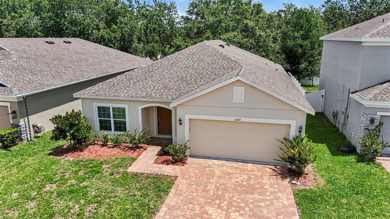 Welcome home to this beautifully maintained, move-in ready residence offering the perfect blend of modern style, functional living, and an unbeatable location. Built just five years ago, this four-bedroom, three-bathroom home features a desirable open-concept design that brings the living room, dining area, and kitchen together into one spacious gathering space—perfect for everyday living and entertaining.

One of the first things you'll notice is the brand-new laminate flooring that flows throughout the entire home, providing a fresh, cohesive look with **no carpet** to maintain. Neutral flooring and wall colors create a timeless backdrop, making it easy to personalize every room with your own style and décor.

The well-appointed kitchen is designed for both beauty and convenience, featuring granite countertops, stainless steel appliances, an oversized pantry with exceptional storage, and plenty of workspace for meal preparation or hosting family and friends. The washer and dryer are also included, making your move even easier.

The thoughtful split-bedroom layout offers flexibility for guests, a home office, or multi-purpose spaces while the three full bathrooms help everyone enjoy added comfort and convenience.

Ideally located with quick access to Narcoossee Road, you'll enjoy an easy commute to Lake Nona, Orlando International Airport, Medical City, shopping, dining, and major roadways while still coming home to a welcoming neighborhood setting.

With modern finishes, spacious living areas, and a location that keeps you connected to everything Central Florida has, this home is ready for its next chapter.