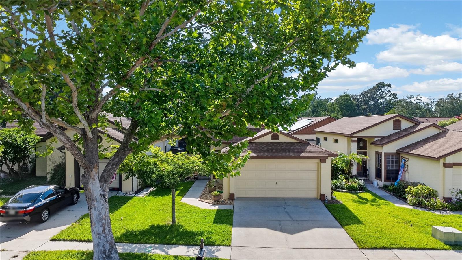 Beautifully updated 3-bedroom, 2-bath home with a desirable split-bedroom floor plan and soaring vaulted ceilings that create a bright, open feel throughout. The spacious living and dining areas flow into the kitchen, which features granite countertops, stainless steel appliances, ample cabinet space, and a breakfast bar. The primary suite offers a walk-in closet, updated walk-in shower, and private access to the screened lanai. Enjoy relaxing or entertaining in the screened patio overlooking the fully fenced backyard. Recent updates include a NEW ROOF (2019), a new dishwasher (2025), a new water heater (2025), fresh interior paint (2025), a new AC (2024), and an updated walk-in shower (2023). A community Olympic-size swimming pool with a screened cabana area, tennis and basketball courts, and a play area. Conveniently located near shopping, restaurants, parks, and major roadways. Some pictures are virtually staged. Move-in ready and waiting for its next owner!