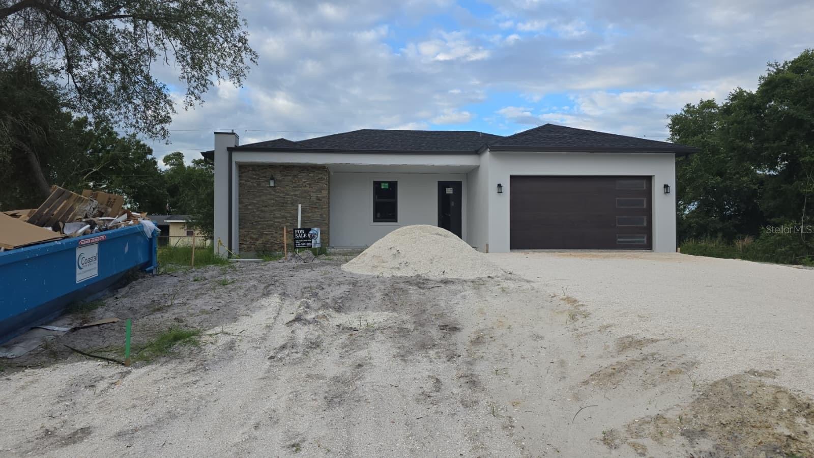 Welcome to this stunning brand-new construction in Port Charlotte! This residence features 3 bedrooms, 2 full bathrooms, and a convenient half bath. Built to the highest standards with solid concrete block construction, this home offers peace of mind with impact windows & doors throughout and a hurricane-rated garage door. Soaring 10-foot ceilings and 8-foot interior doors with chrome hardware create a grand, airy feel, while large-format tile flooring runs throughout every room. The open-concept floor plan seamlessly connects the living room, dining area, and kitchen, creating a bright and inviting space ideal for both everyday living and entertaining. The kitchen is the centerpiece of the home, showcasing quartz countertops, high-end white cabinetry, a large center island, LG stainless steel appliances, recessed lighting, and under-cabinet lighting. The spacious primary suite offers a private retreat with a walk-in closet and primary bathroom, while the secondary bedrooms provide generous closet space. Additional highlights include ceiling fans with integrated lighting, recessed lighting throughout the home, an interior laundry room complete with Samsung washer and dryer, and a two-car garage. Step outside to the covered rear lanai, perfect for enjoying Florida's year-round sunshine, outdoor dining, or relaxing with family and friends. Located in a convenient Port Charlotte location with no HOA or CDD, this home provides easy access to shopping, dining, medical facilities, and everyday conveniences. Residents enjoy being just a short drive from Charlotte Harbor, waterfront parks, public boat ramps, fishing, golf courses, and the beautiful Gulf Coast beaches of Boca Grande and Englewood. You're minutes from top-rated Gulf beaches, Sunseeker Resort, shopping, dining, golf courses, I-75 access, and the spring training home of the Tampa Bay Rays. Call us today for a showing!