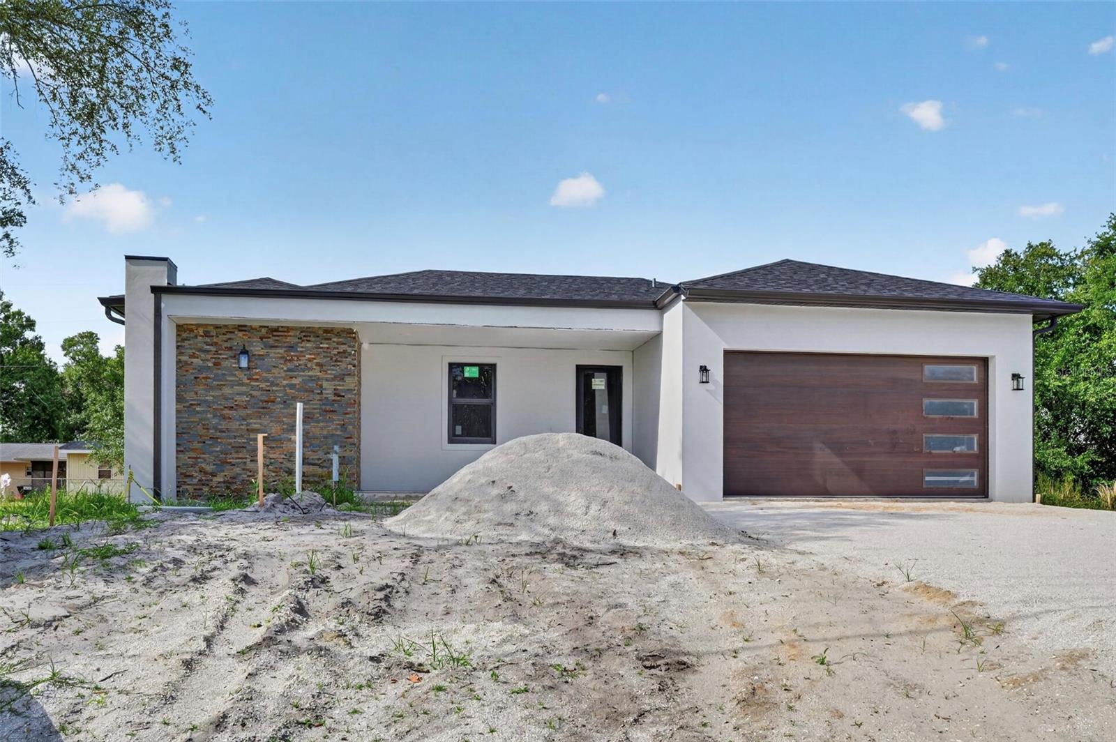 Welcome to this stunning brand-new construction in Port Charlotte! This residence features 3 bedrooms, 2 full bathrooms, and a convenient half bath. Built to the highest standards with solid concrete block construction, this home offers peace of mind with impact windows & doors throughout and a hurricane-rated garage door. Soaring 10-foot ceilings and 8-foot interior doors with chrome hardware create a grand, airy feel, while large-format tile flooring runs throughout every room. The open-concept floor plan seamlessly connects the living room, dining area, and kitchen, creating a bright and inviting space ideal for both everyday living and entertaining. The kitchen is the centerpiece of the home, showcasing quartz countertops, high-end white cabinetry, a large center island, LG stainless steel appliances, recessed lighting, and under-cabinet lighting. The spacious primary suite offers a private retreat with a walk-in closet and primary bathroom, while the secondary bedrooms provide generous closet space. Additional highlights include ceiling fans with integrated lighting, recessed lighting throughout the home, an interior laundry room complete with Samsung washer and dryer, and a two-car garage. Step outside to the covered rear lanai, perfect for enjoying Florida's year-round sunshine, outdoor dining, or relaxing with family and friends. Located in a convenient Port Charlotte location with no HOA or CDD, this home provides easy access to shopping, dining, medical facilities, and everyday conveniences. Residents enjoy being just a short drive from Charlotte Harbor, waterfront parks, public boat ramps, fishing, golf courses, and the beautiful Gulf Coast beaches of Boca Grande and Englewood. You're minutes from top-rated Gulf beaches, Sunseeker Resort, shopping, dining, golf courses, I-75 access, and the spring training home of the Tampa Bay Rays. Home is currently under construction and is expected to be completed in July 2026. Call us today for a showing!