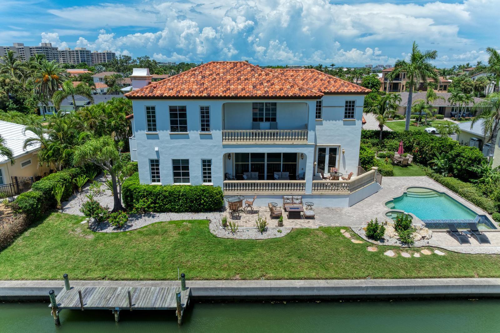 Under contract-accepting backup offers. Motivated seller ….ELEVATED Waterfront Luxury on Longboat Key! Welcome to 550 Yardarm Lane, where the elegance of Longboat Key meets the ease of Florida’s coastal lifestyle in the coveted Country Club Shores. This waterfront masterpiece isn’t just a home, it’s your front-row seat to paradise, where boating, beach walks, and year-round sunshine are part of everyday life. Step inside and be instantly captivated by sparkling water views, soaring spaces, and the perfect blend of casual comfort and refined luxury. Designed for both relaxation and unforgettable entertaining, this 5-bedroom, 5.5-bath retreat is tailor-made for hosting family and friends in style. PRIME WATERFRONT LIVING - Private dock on a deep-water canal with no-bridge access to the bay, perfect for your weekend cruiser. LIGHT & BRIGHT OPEN LAYOUT - Walls of glass bring the outdoors in, filling the home with sunshine and stunning water views. ELEVATOR - Effortless access to main living levels from the three car garage. CHEF’S DREAM KITCHEN - High-end appliances, custom cabinetry, and an oversized island ready for gourmet meals and lively gatherings. LUXURIOUS SUITES - Owner’s retreat with a private balcony, spa-inspired bath, and dual walk-in closets. MOVIE ROOM - Your own private theater for cozy nights in. OUTDOOR OASIS - infinity pool, spacious patio, and lush landscaping for poolside lounging or sunset soirees. All this just steps to your DEEDED BEACH ACCESS and minutes from the world-class dining, shopping, and cultural treasures of St. Armands Circle and Downtown Sarasota. Whether you’re dreaming of a full-time Florida home or a seasonal escape, 550 Yardarm Lane delivers the ultimate Longboat Key lifestyle.