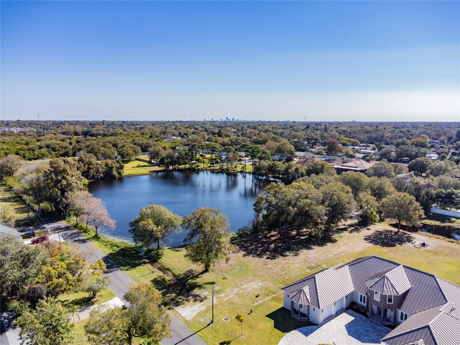 Residential Lakefront Lots are hard to find on Florida's Suncoast in Pinellas County. Don't miss this opportunity to build your dream home on this beautiful waterfront lot at Ranch Lake Estates. Over 200 feet of lakefront offers outstanding water views. The lot has several mature oak trees that accent the property. Public electricity, water, and sewer are available here. Newer homes have already been built. Also, a recent (2021) survey is available. Ranch Lake Estates is conveniently located near shopping, dining, major roads, the top-rated beaches in the USA, and Tampa Bay's world-class sports and entertainment events. The community has the feel of being in a quaint rural area. Don't miss the opportunity to own this rare lakefront residential lot.
