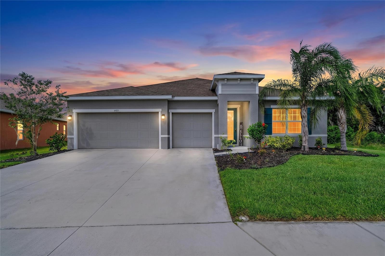 Exquisite upgraded home, designed to impress from the moment you walk through the front door with water views of the beautiful lake. Built in 2022, the expansive open floor plan features elegant, upgraded luxury vinyl and ceramic tile flooring throughout. The highlight of this home is the open living space overlooking the lake directly behind the home, and a designer custom kitchen outfitted with granite counters, stainless steel appliances, center island with breakfast bar with pendent lighting, soft close cabinets and drawers, built-in double oven, glass tile backsplash, under-cabinet lighting and walk-in pantry. The primary suite is a tranquil retreat with relaxing water views through large windows, tray ceiling and direct door access to your screened-in lanai. The en-suite luxurious primary bathroom boasts a spacious frameless glass Roman shower with built-in bench, dual rain shower heads, private toilet room, double vanity and dual sinks. A large walk-in closet enhances functionality and there is plenty of space to add additional shelving. At the front of the home, two spacious bedrooms feature ample closet space and share a luxurious hallway bathroom with a double vanity and bathtub. Across the hallway, a fourth bedroom with an ensuite private bathroom provides ideal accommodations for guests. There's also a versatile bonus room, perfect for a home office, playroom or fitness room. The spacious 3-car garage is updated with epoxy floors and three ceiling storage shelves for all you holiday decorations. The unique feature for the location of the property is there is only one neighbor next door as the other side of the home is unbuildable vacant land. Experience the best of Florida living with this exceptional home, ideal for both relaxation and entertainment. Plenty of space in the backyard to add a swimming pool or install a fence. With no CDD fees and a low HOA ($100/month), residents can enjoy community amenities, located within a short walk from the home, including a community pool, tennis court, playground, park and walking trails. Conveniently located near top-rated schools, shopping, and dining. Don’t miss the opportunity to make this stunning home yours! Schedule your showing today.