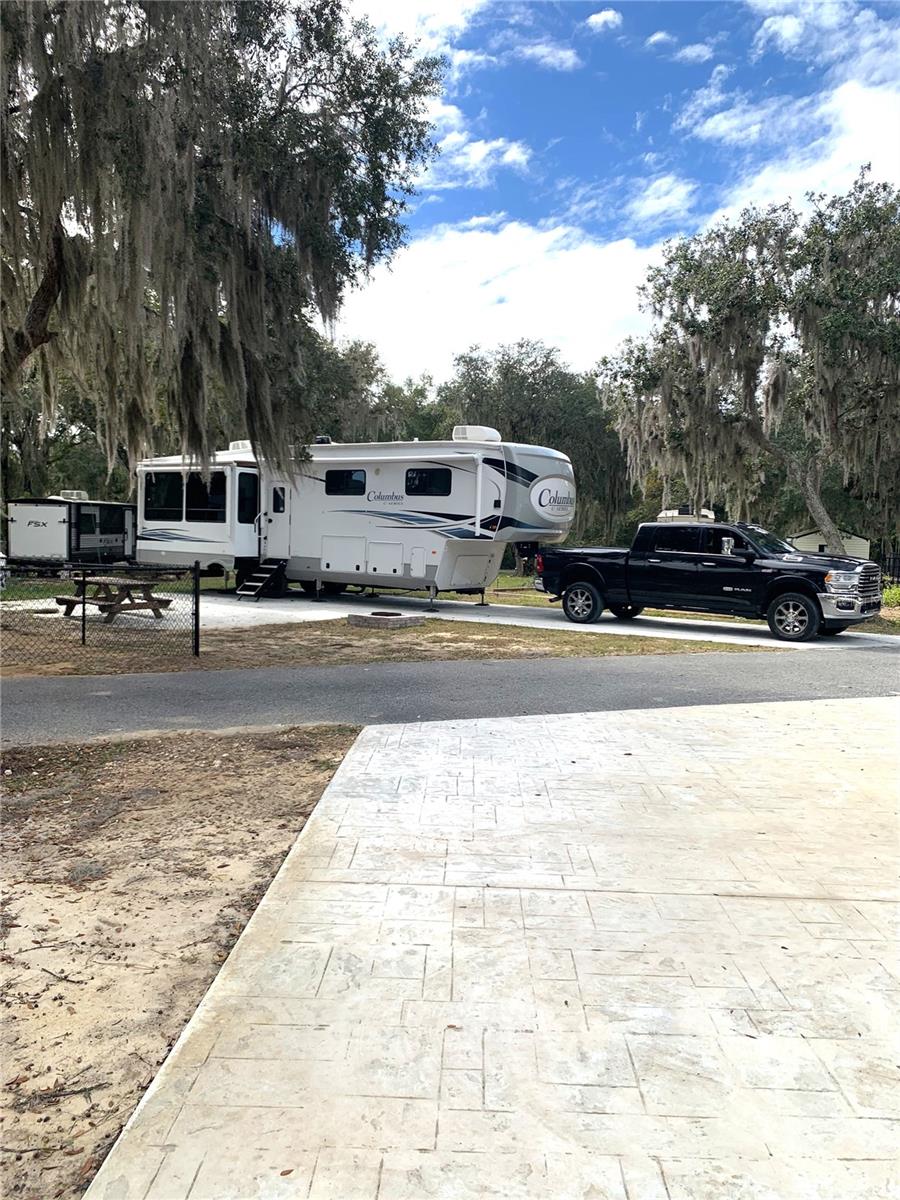 Experience resort-style living in this inviting RV lot at Lake Oklawaha Resort, perfectly situated within the breathtaking Ocala National Forest. Whether you're seeking a peaceful retreat or an adventure-filled getaway, this lot provides the ideal home base in a vibrant, amenity-rich community.
The resort overlooks and offers direct access to Lake Oklawaha, a stunning 12,000-acre lake known for its natural beauty, fishing, boating, and unforgettable sunsets—an unparalleled setting for outdoor enthusiasts and nature lovers.
Enjoy access to a wide range of recreation and comfort features, including a 6,500 sq. ft. activity lodge complete with a junior Olympic–sized pool, perfect for cooling off or lounging in the Florida sunshine. The resort also offers a convenient General Store for personal items and camping essentials, along with modern laundry and bathhouse facilities to make extended stays effortless.
 Outdoor lovers will appreciate the direct access to the Ocala National Forest Trail, offering endless opportunities for hiking, ATV riding, and exploring wildlife. On-site amenities include a shaded dog park, community playgrounds, corn hole, horseshoes, volleyball, live music/DJ events, and movie nights, ensuring fun for all ages.
Guests can enjoy complimentary Wi-Fi with optional high-speed upgrades available, plus the convenience of on-demand grocery delivery service right to your campsite. Electric, water, and trash pick-up are also included in your low association fees.
With its ideal location, impressive amenities, and unmatched natural surroundings, this RV lot offers the perfect blend of relaxation, recreation, and modern convenience. A must-see opportunity for seasonal stays, weekend escapes, or investment potential!