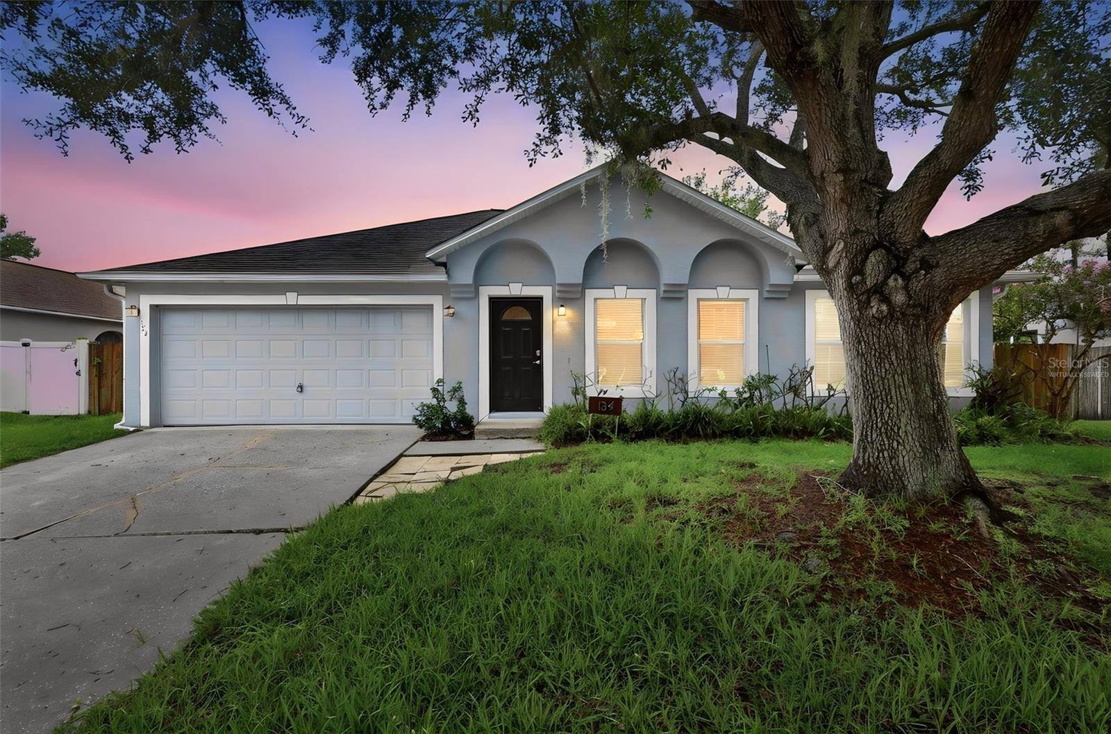 Virtually Staged. This 4-bedroom, 2-bath home in Crown Colony offers a single-story layout with a 2-car garage, fenced backyard, screened rear porch, and updated interior finishes. The main living areas feature vaulted ceilings, wide-plank style flooring, neutral paint, arched architectural details, and flexible living/dining spaces. The kitchen has been updated with blue-gray cabinetry, stone-style counters, tile backsplash, stainless appliances, center island, and pantry storage.

The split bedroom plan gives separation between the primary suite and secondary bedrooms. The primary bath includes a dual vanity, soaking tub, and separate shower. Secondary bedrooms provide options for family, guests, or office space. Outdoor areas include a screened rear porch, fenced yard, and paver patio/fire pit area.

Crown Colony is located near the Sanford/Lake Mary corridor with access to Historic Downtown Sanford, the Sanford Riverwalk, Lake Monroe, Lake Mary, Colonial TownPark, Seminole Towne Center, SunRail, Amtrak Auto Train, Orlando Sanford International Airport, I-4, and SR-417.