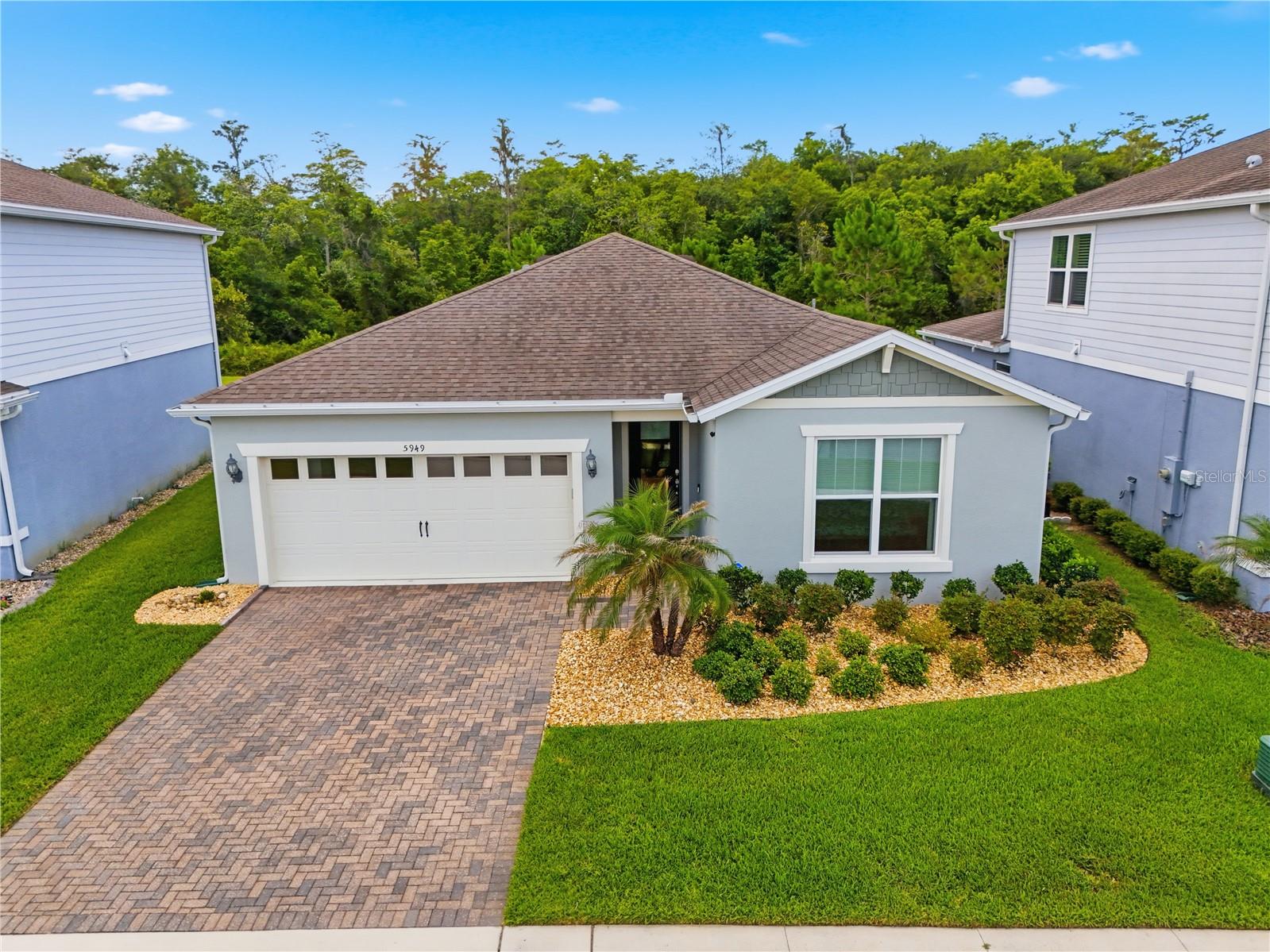 Welcome to your private oasis at 5949 Wooden Pine in Pinewood Reserve. Why wait to build when this beautiful, 2020-built 3-bedroom, 2-bathroom POOL HOME is completely move-in ready? Designed to be your personal sanctuary, this turnkey property perfectly balances modern style with everyday comfort, giving you a deep sense of relief the moment you walk through the door. Inside, the spacious open floorplan features durable porcelain tile flowing through the main living areas and luxury vinyl flooring in the bedrooms. At the heart of the home is a stunning chef's kitchen, complete with a large island and gleaming quartz counters that offer plenty of prep space and abundant storage for all your culinary needs. The primary suite serves as a true retreat, highlighted by a generous, custom built-out closet to keep you organized. Adding to the home's pristine feel is a spotless 2-car garage finished with premium epoxy flooring, offering a polished, durable space for your vehicles, extra storage, or a weekend workshop.
*****************************************************************************************************************

Step outside to discover the true highlight of this property: your very own stunning pebble-tech saltwater pool. Imagine your weekends starting with a quiet morning coffee on the covered and screened back lanai, followed by an afternoon of swimming and sunbathing. The upgraded paver back patio creates the ultimate space for hosting weekend barbecues or simply relaxing in the shade. Backing up to serene conservation with NO REAR NEIGHBORS, the large, fully fenced backyard offers exceptional privacy, making you feel completely secluded in your own tranquil retreat after a long week. This home is fully outfitted with modern smart technology focused on safety, featuring an integrated security and camera system, keyless entry points with app-controlled garage access, a smart thermostat, and built-in surround sound in the living room.

Beyond your front door, the Pinewood Reserve community offers endless ways to elevate your downtime—all with the incredible financial benefit of NO CDD fees. Spend your weekends enjoying the resort-style community pool, playground, and scenic walking trails. Just a short 0.4-mile walk away is Young Pine Community Park, where you can spend your Saturdays gliding across the lake on a paddleboard or kayak, exploring hiking trails, or enjoying an active playdate at the dog park. Whether you are commuting for work or heading out for weekend entertainment, travel is a breeze with easy access to major highways like SR-417, 408, and 528. This prime location places you within 15 minutes of Lake Nona, the Orlando International Airport (MCO), Downtown Orlando, UCF, and the bustling shopping and dining at Waterford Lakes.