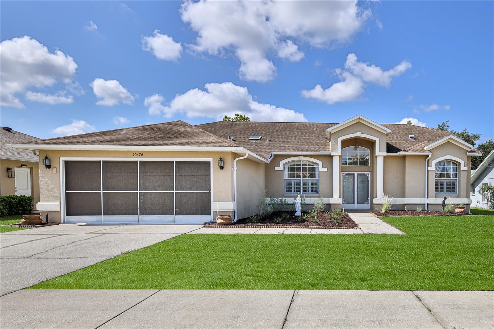 Virtually Staged. Enjoy Florida living in this well-maintained 3-bedroom, 2-bath, 2 car garage, pool home in the desirable Seven Hills community. Featuring an oversized screened pool deck, split-bedroom floor plan, plantation shutters, granite countertops, and 1,825 square feet of living space, this home is designed for comfortable everyday living and entertaining. Enter through double front doors into the spacious living and dining room featuring soaring ceilings, plantation shutters, decorative lighting, and three-panel sliding glass doors that showcase views of the screened pool, lanai and beyond. 
The split-bedroom floor plan provides privacy for the owner's suite, complete with lanai access, two oversized walk-in closets with built-in shelving, and an en-suite bath featuring dual vanities, a jetted soaking tub and separate walk-in shower. 
The kitchen offers granite countertops, an updated tile backsplash, newer appliances, pantry storage, and generous cabinet and counter space. The adjoining breakfast nook features built-in shelving and sliding glass doors leading to the covered lanai. The laundry room includes a utility sink, washer and dryer, cabinetry, and an additional pantry.
Guest bedrooms are generously sized with plantation shutters and large walk-in closets. The guest bath includes a tub/shower combination, newer commode, linen storage, and convenient pool access. Step outside to enjoy the screened in-ground pool, oversized pool deck, covered lanai with ceiling fan, and an additional paver patio overlooking peaceful backyard views—ideal for relaxing or entertaining family and friends. Additional features include HVAC (2021) Roof (2012) plantation shutters, no popcorn ceilings, and a desirable Seven Hills location convenient to shopping, dining, medical facilities, and the Suncoast Parkway.
