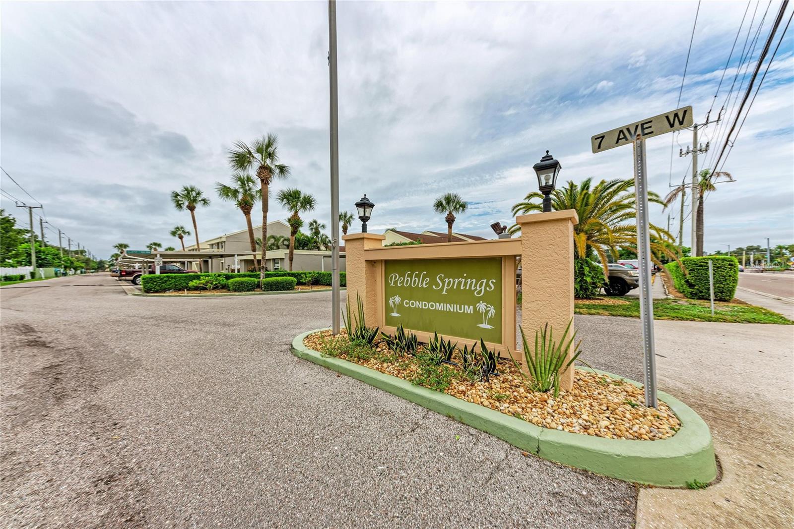 Enjoy the convenience of West Bradenton living in the desirable Pebble Springs community. Ideally located near shopping, restaurants, medical offices, hospitals, schools, and the public bus line, this home is just 5 miles from the pristine beaches of Anna Maria Island. Outdoor enthusiasts will appreciate the nearby Robinson Preserve, Palma Sola Botanical Park, G.T. Bray Park, the Bradenton Riverwalk, and vibrant Downtown Bradenton. Tampa, St. Petersburg, and Sarasota attractions are all within an easy one-hour drive. This well-maintained, ground-floor 2-bedroom, 2-bath condominium is move-in ready and offers a comfortable split-bedroom floor plan for added privacy. The spacious living and dining area features a convenient pass-through to the kitchen, creating an open and inviting atmosphere. The primary suite includes a walk-in closet, vanity area, and private bath with a walk-in shower. The guest bedroom is adjacent to the second bath with a tub/shower combination, making it ideal for family and visitors. Relax on the screened lanai with desirable southern exposure overlooking the beautifully landscaped courtyard and heated community pool. A storage closet provides additional space, while an assigned carport just steps from the unit and one additional open parking space are included. Being offered furnished, this home provides the perfect opportunity to move right in and personalize with your own updates and designer touches over time. Pebble Springs is a non-age-restricted community featuring a clubhouse and community pool. Residents of Cluster V enjoy their own heated courtyard pool and gas grill, where friendly neighbors often gather for holidays and social events. One small pet is welcome (maximum 15 pounds at maturity). New Roof 2025. The monthly condominium fee is among the lowest in the community and includes building insurance, exterior and grounds maintenance, roof, reserves, professional management, pest control, cable, internet, water, sewer, trash, and recreational amenities.