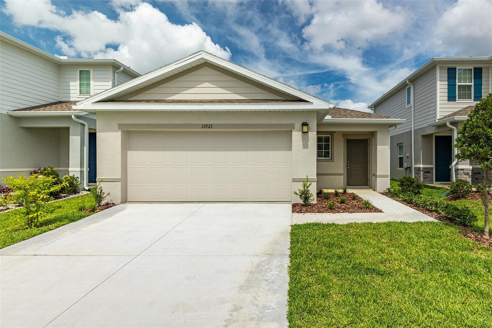 Welcome home to this beautifully maintained 3-bedroom, 2-bathroom home with a 2-car garage, ideally located near the Spring Hill and Land O' Lakes border. Offering 1,500 square feet of thoughtfully designed living space, this home features a bright, open-concept layout that is perfect for both everyday living and entertaining. The spacious great room flows seamlessly into the dining area and modern kitchen, complete with a large center island, abundant cabinet space, and plenty of room for preparing meals or gathering with family and friends. Sliding glass doors lead to the covered lanai, creating a comfortable space to enjoy the Florida lifestyle. The private owner's suite features an oversized walk-in closet and an en-suite bathroom with dual vanities. Two additional bedrooms and a full bathroom provide flexibility for family, guests, or a home office. Conveniently located just minutes from US-41, SR 56, the Suncoast Parkway, I-75, and US-301, this home offers quick access to shopping, dining, schools, parks, medical facilities, and an easy commute to Tampa and surrounding areas.