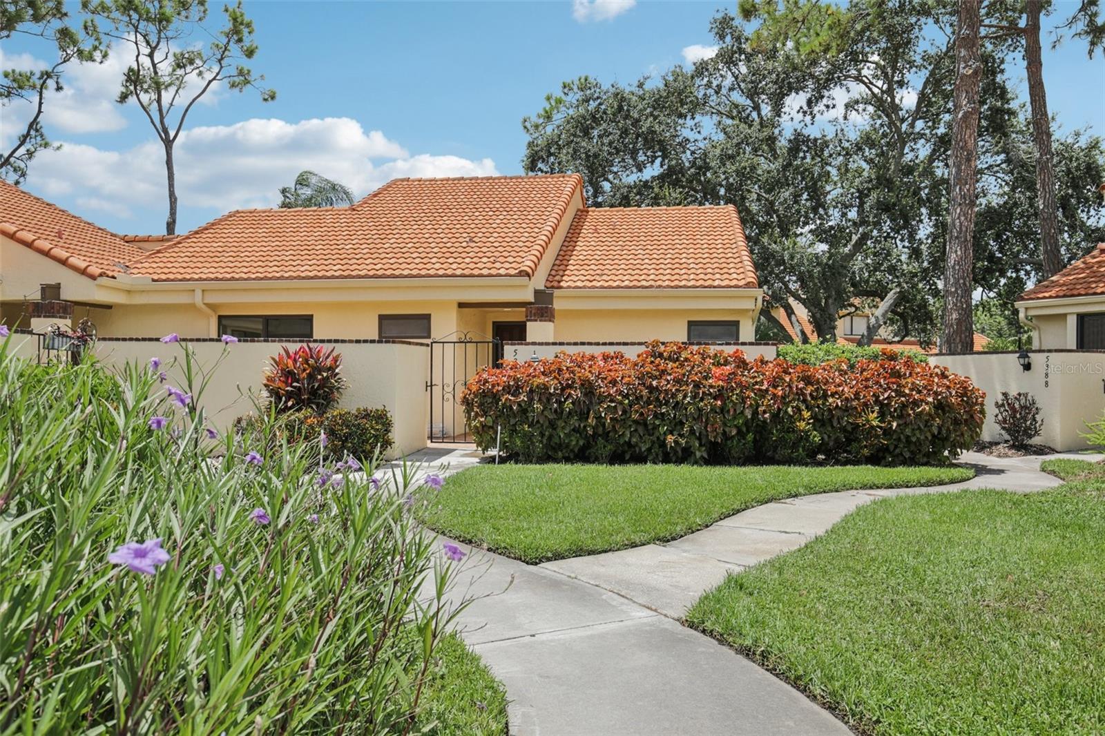 Stylishly renovated 2-bedroom, 2-bath villa in The Meadows, one of Sarasota’s most established and centrally located communities. This light-filled, move-in ready home features vaulted ceilings, an open-concept layout, and updated laminate wood flooring throughout. The kitchen has been refreshed with updated cabinetry, ample counter space, a double sink, and stainless steel appliances. A raised dining area adds flexibility to the living space.
The property offers three distinct outdoor areas, including a screened lanai with wood-beam ceiling and ceiling fan, as well as a wraparound garden patio with multiple access points from the living room and both bedrooms—ideal for outdoor living and relaxation.
The split-bedroom floor plan provides privacy, and both bathrooms have been updated. The primary suite includes dual vanities, a walk-in shower, and generous closet space.
Located in a well-maintained, amenity-rich community with convenient access to shopping, dining, golf, parks, and Sarasota’s Gulf beaches. Priced at $265,000, this property represents one of the best values in The Meadows.