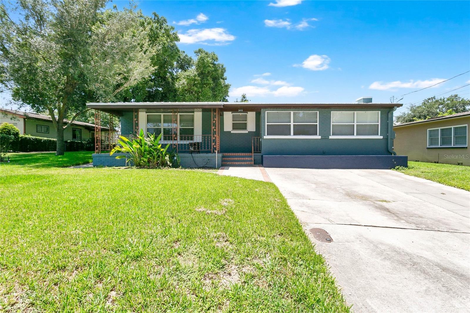 Tucked in one of Orlando's most sought-after areas, this 1955 charmer is move-in ready and has been thoughtfully updated. The front porch welcomes you with arms wide open. It's the kind of porch that's built for rainy days and afternoons where you wave to your neighbors.
Inside, the space is bright and open so the conversation never has to stop, whether you're cooking, catching up, or just keeping an eye on the game. The kitchen has been remodeled down to the studs, with white shaker cabinets, granite counters, glass-front uppers, and stainless appliances ready for anything you want to make. Beyond the kitchen, the family room gives you a second place to gather, centered on a brick fireplace built for movie nights and quiet evenings. Original hardwood oak floors have been completely repaired and refinished, carrying that same warmth through every room. The primary bedroom gives you a walk-in closet and an ensuite bath that's been freshly renovated. The second bedroom and guest bathroom are just around the corner. Step outside and the backyard is yours to shape. It's large and partially shaded by mature oak trees, with room for a garden, a fire pit, or a pool (or all three). You also won't spend your first year here writing checks for someone else's neglect. The roof was replaced in 2021 with galvanized metal and hidden fasteners. The AC is a 2023 Ruud two-ton, 14 SEER system. The electric was updated in 2012 with a partial rewire and removal of outdated panels, and the home was fully replumbed that same year. The drainfield and septic tank lid were addressed in 2023, and the primary bath was renovated in 2025. Zoned for Boone High School (GO BRAVES!), this home puts you close to everything the area offers while keeping its 1955 character fully intact.