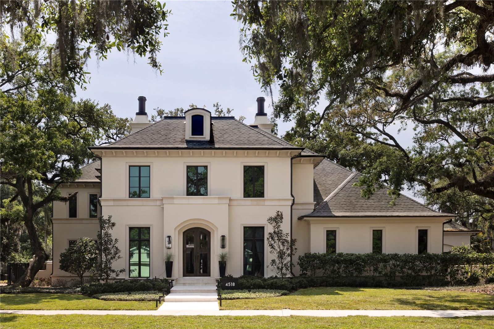 Under contract-accepting backup offers. An exceptional Windstar custom-built estate in South Tampa’s coveted Beach Park neighborhood, where refined design meets resort-style living. Completed in 2018 and enhanced in 2022, this impressive residence spans over 6,200 square feet and is thoughtfully designed for elevated everyday living and unforgettable entertaining. At the heart of the home is a gourmet kitchen—a true culinary showpiece—featuring dual oversized islands, ideal for hosting and gathering. Outfitted with Sub-Zero refrigeration, a Wolf gas range, two dishwashers, two sinks, an expansive walk-in pantry, and ample storage space. This kitchen seamlessly blends function and performance, making it a standout for chefs and entertainers alike. The home offers five bedrooms, five full bathrooms, and two half bathrooms, including a luxurious primary suite retreat complete with a cozy gas fireplace, custom closets, and separate his-and-her bathrooms designed for comfort and privacy. Additional interior amenities include an elevator, a spacious laundry room with dual washers and dryers with dedicated crafting space, and abundant storage throughout. Outdoor living is nothing short of extraordinary. Set on an oversized 140 x 144 lot (approximately 0.46 acres), the backyard has been designed as a private resort, featuring a freshly resurfaced pickleball court, putting green, gas fire pit, and a resort-style swimming pool with a slide, all surrounded by generous green space for recreation and relaxation. The first-floor living room opens seamlessly to an expansive covered lanai with phantom electric screens and a fully equipped summer kitchen, creating the ultimate indoor-outdoor entertaining experience. Car enthusiasts will appreciate the two two-car garages with three lifts, offering space for up to seven vehicles. A third-floor bonus room with a full bath and closet provides flexible use as a fifth bedroom, guest or nanny suite, fitness studio, or playroom. The first floor also includes a large bonus/playroom, home office, and family room—each designed for comfort and versatility. Completed with a Generac Home Generator, this exceptional Beach Park estate delivers a rare combination of luxury, lifestyle, and functionality in one of South Tampa’s most desirable neighborhoods.
